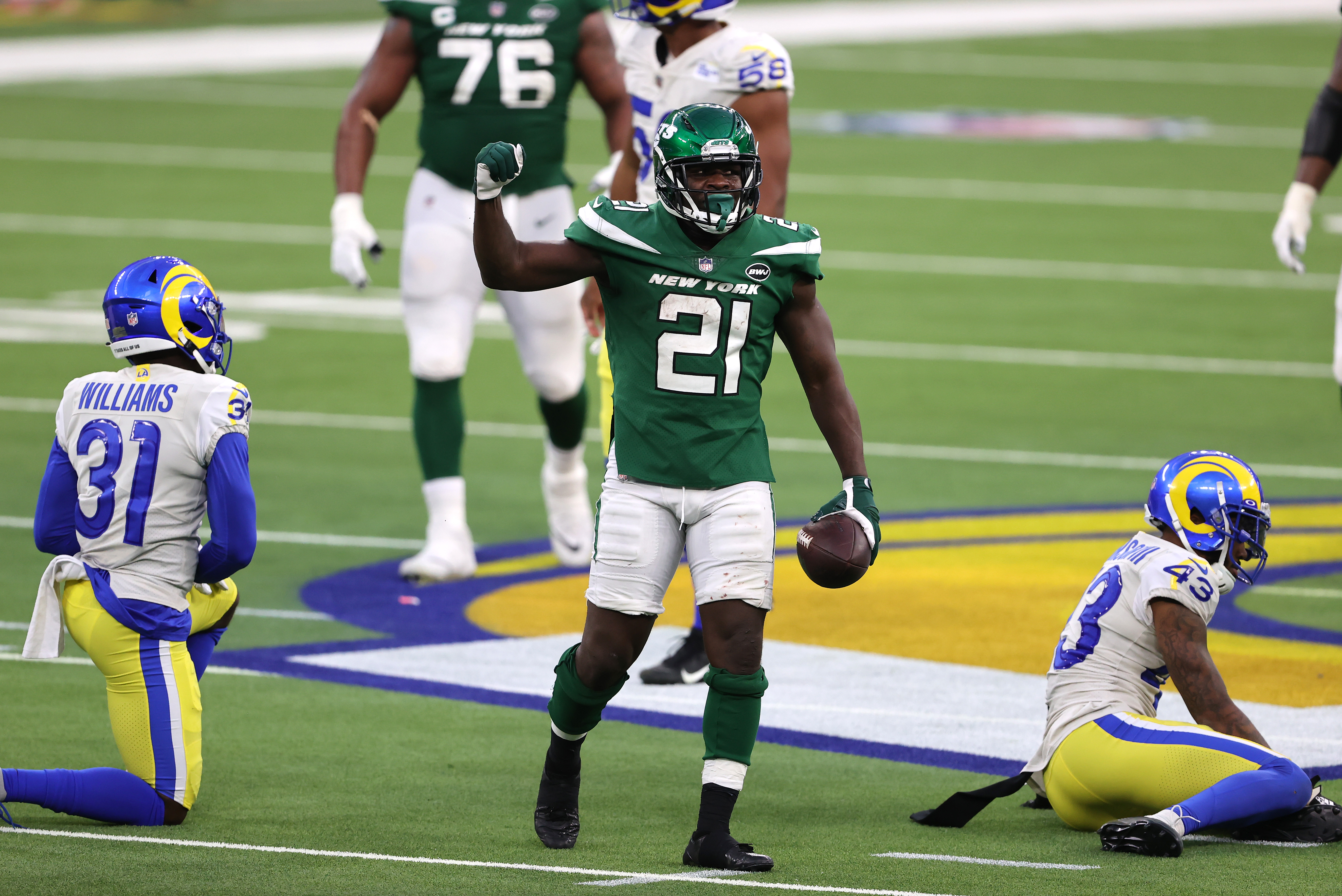 Darious Williams #31 and John Johnson #43 of the Los Angeles Rams look on as Frank Gore #21 of the New York Jets reacts to extra yards during the second half of a game at SoFi Stadium on December 20, 2020 in Inglewood, California.