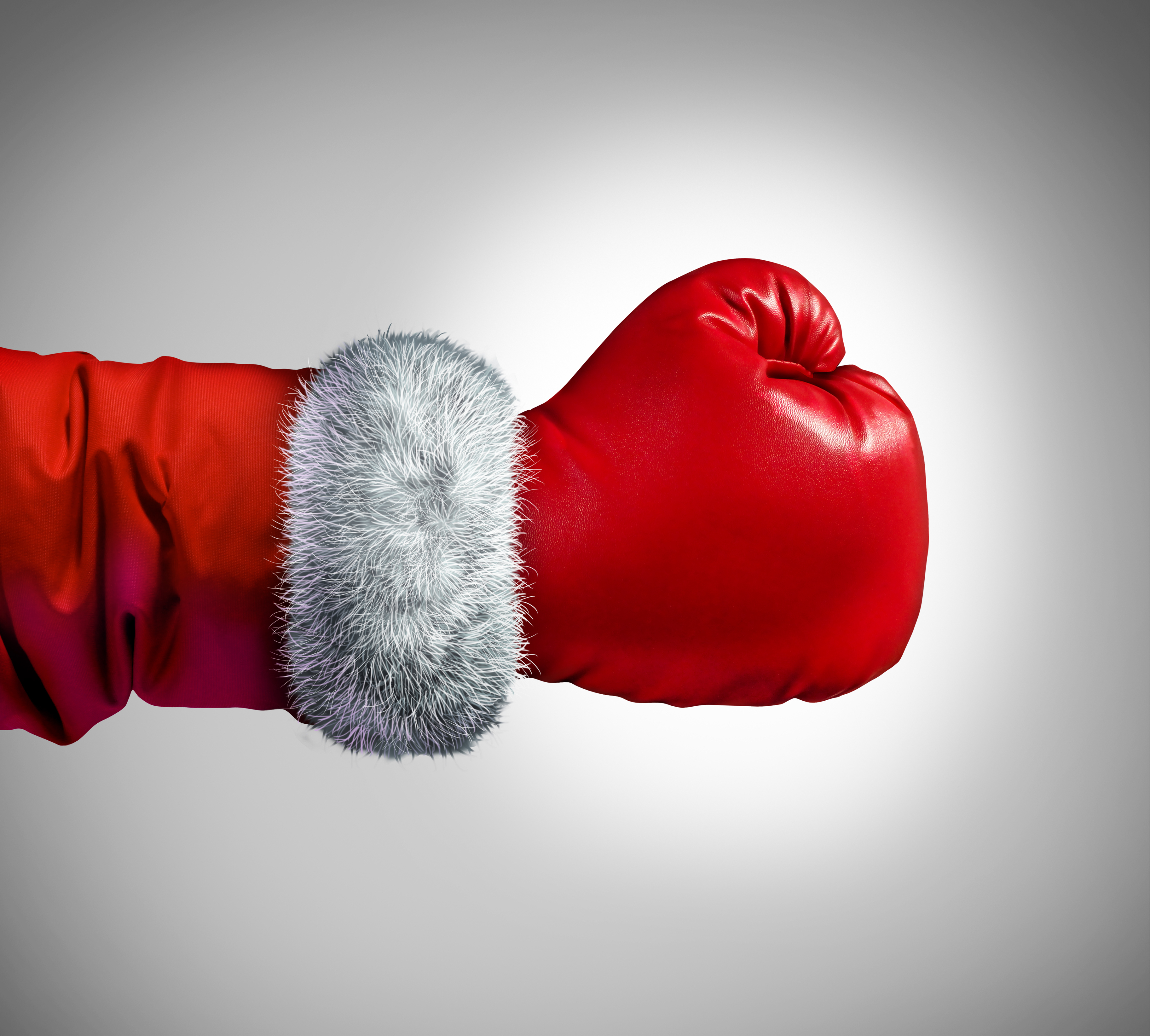 A boxing glove on the arm of someone wearing a Santa suit.