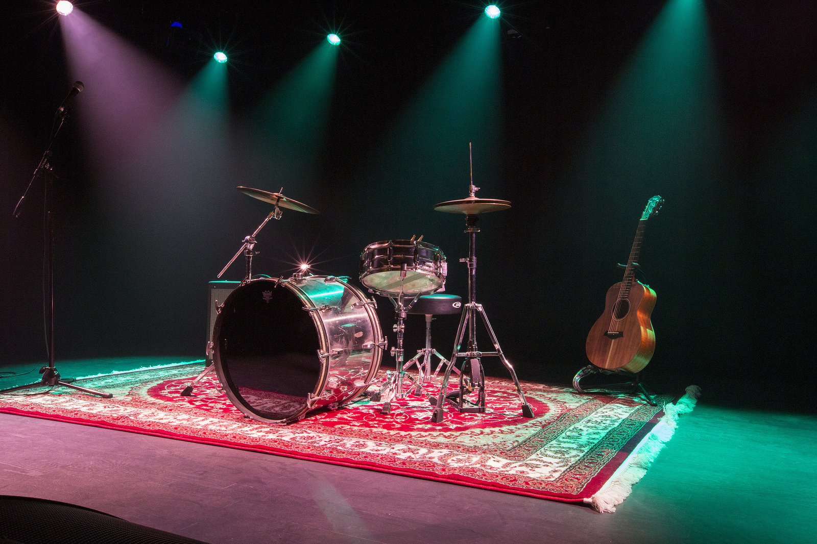 An empty stage with a drum kit.