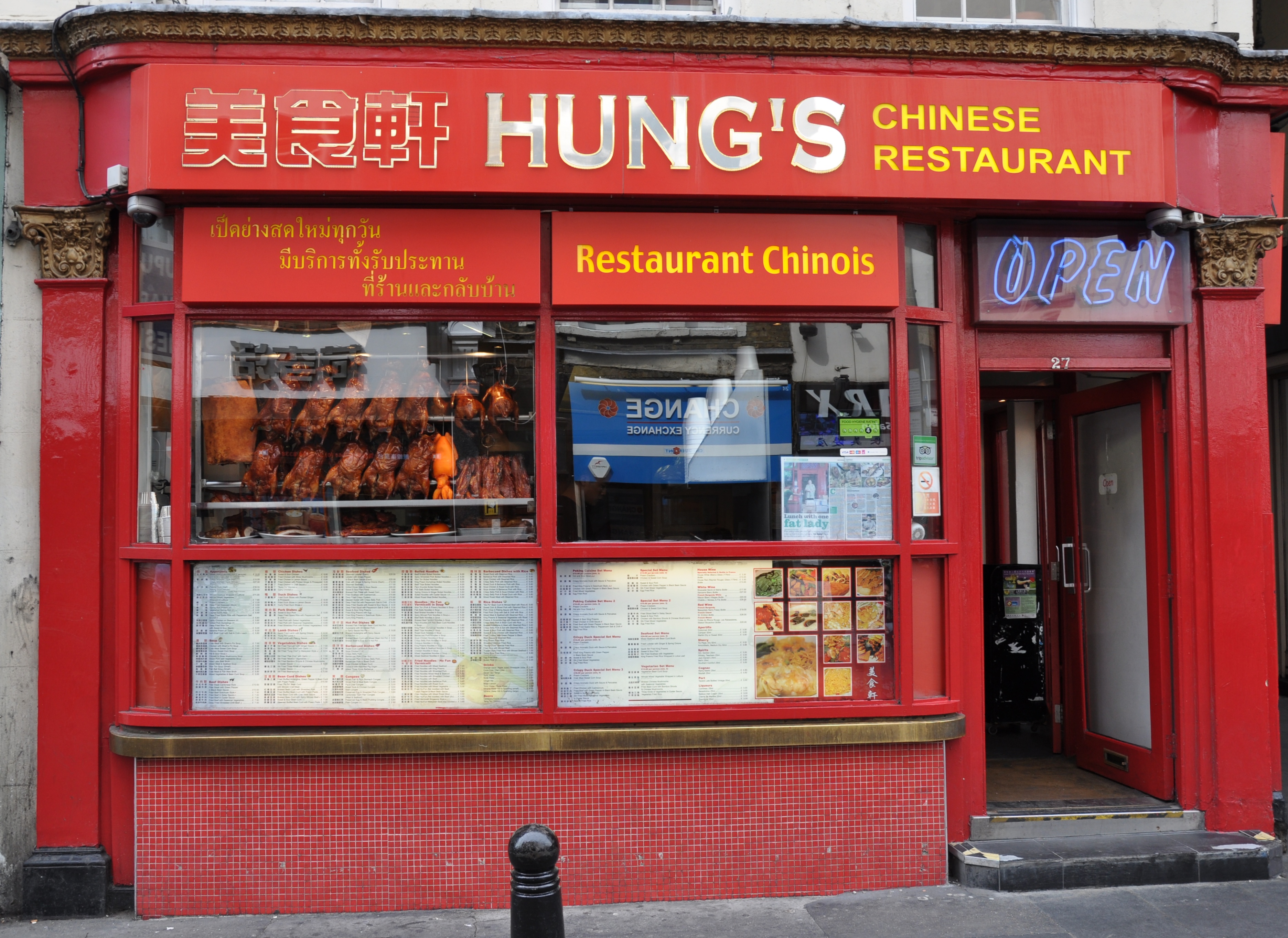The exterior of Hung’s restaurant on Wardour Street, Chinatown, London, painted red with roast ducks in the window