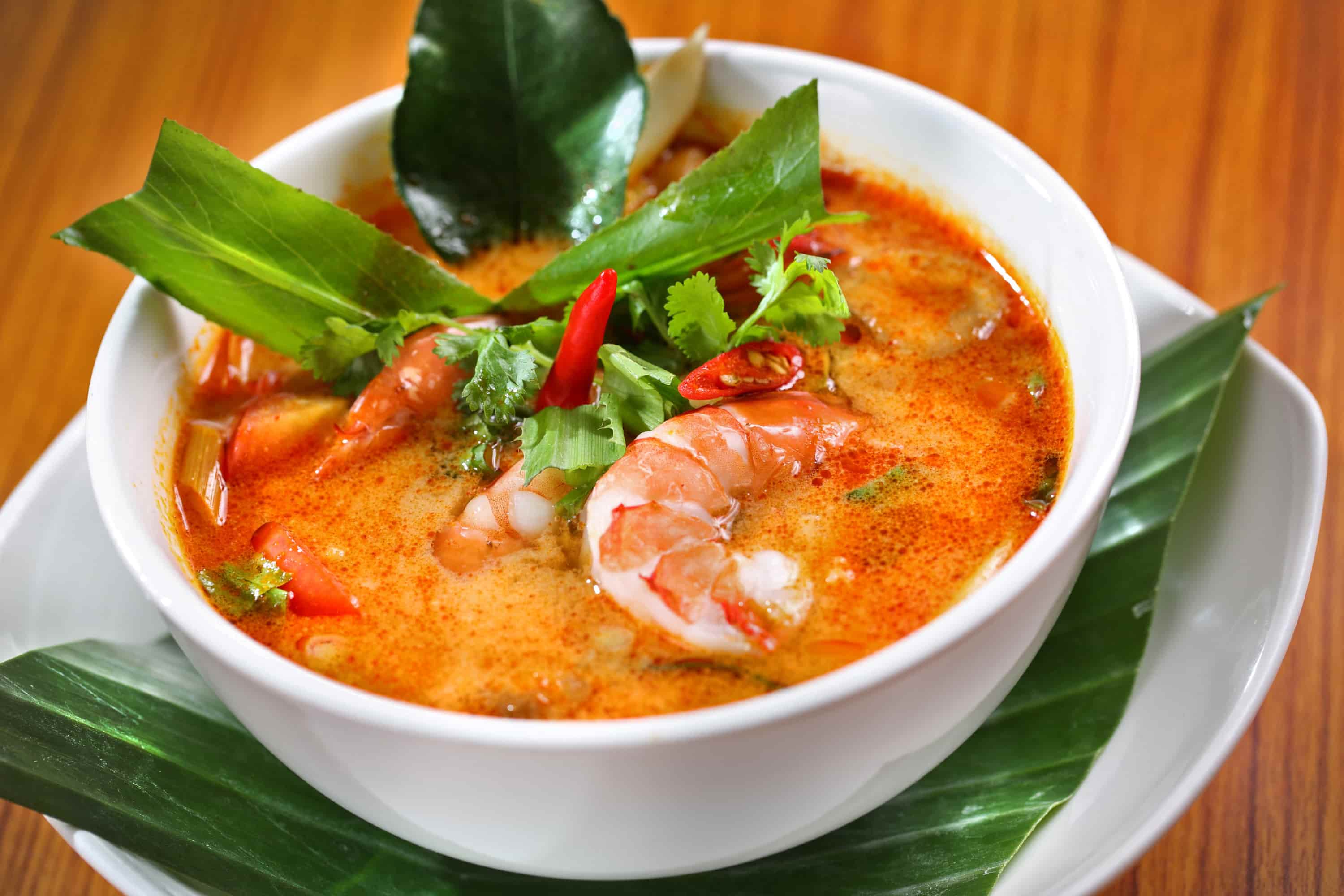 A big bowl of Thai soup with shrimp