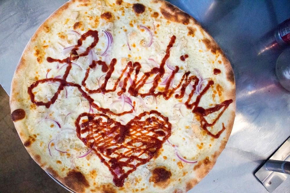 A New York-inspired white pie, decorated in sauce with the name of Landini’s Pizzeria, coming soon to the southwest.
