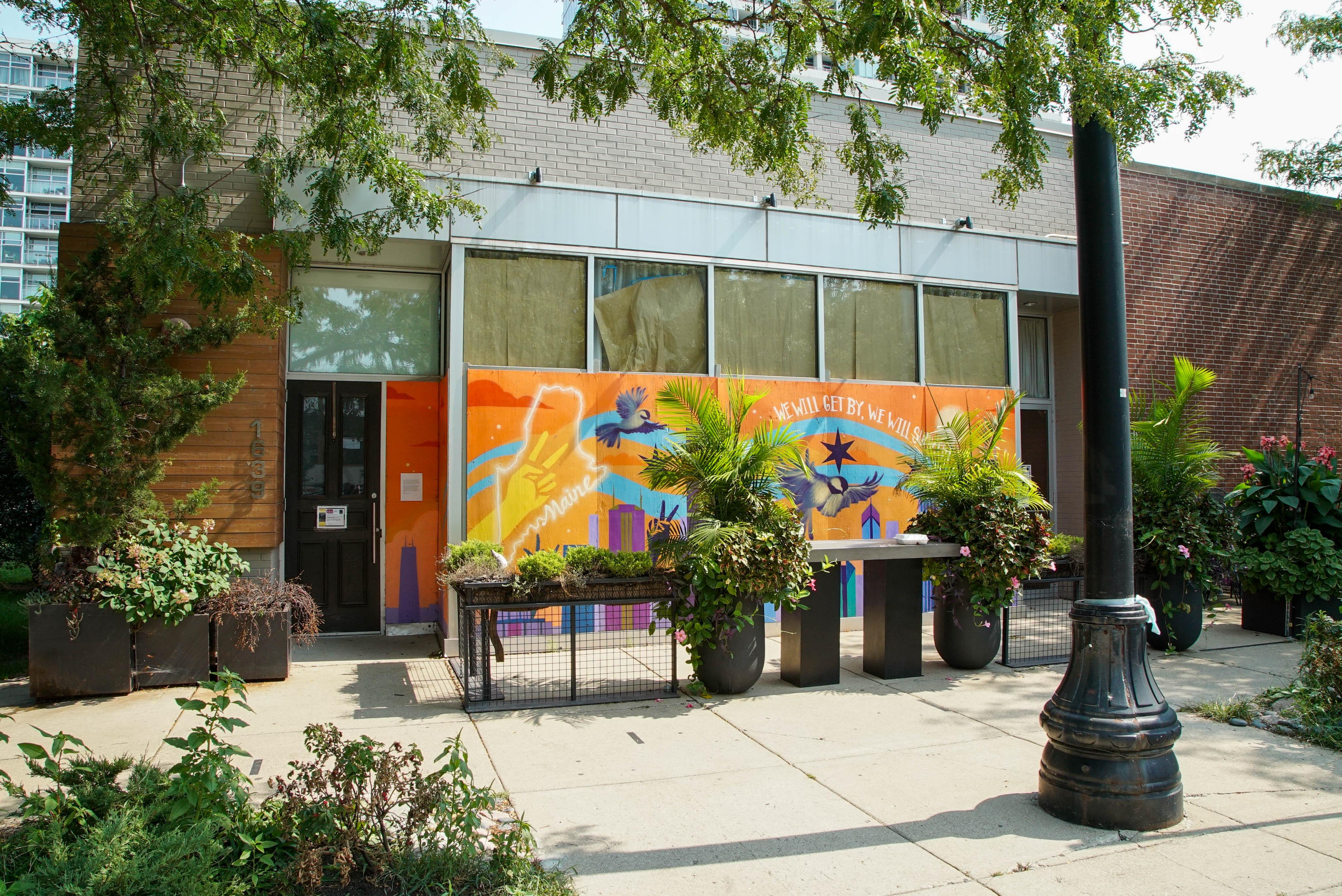 The exterior of a colorful restaurant taken from across the street.