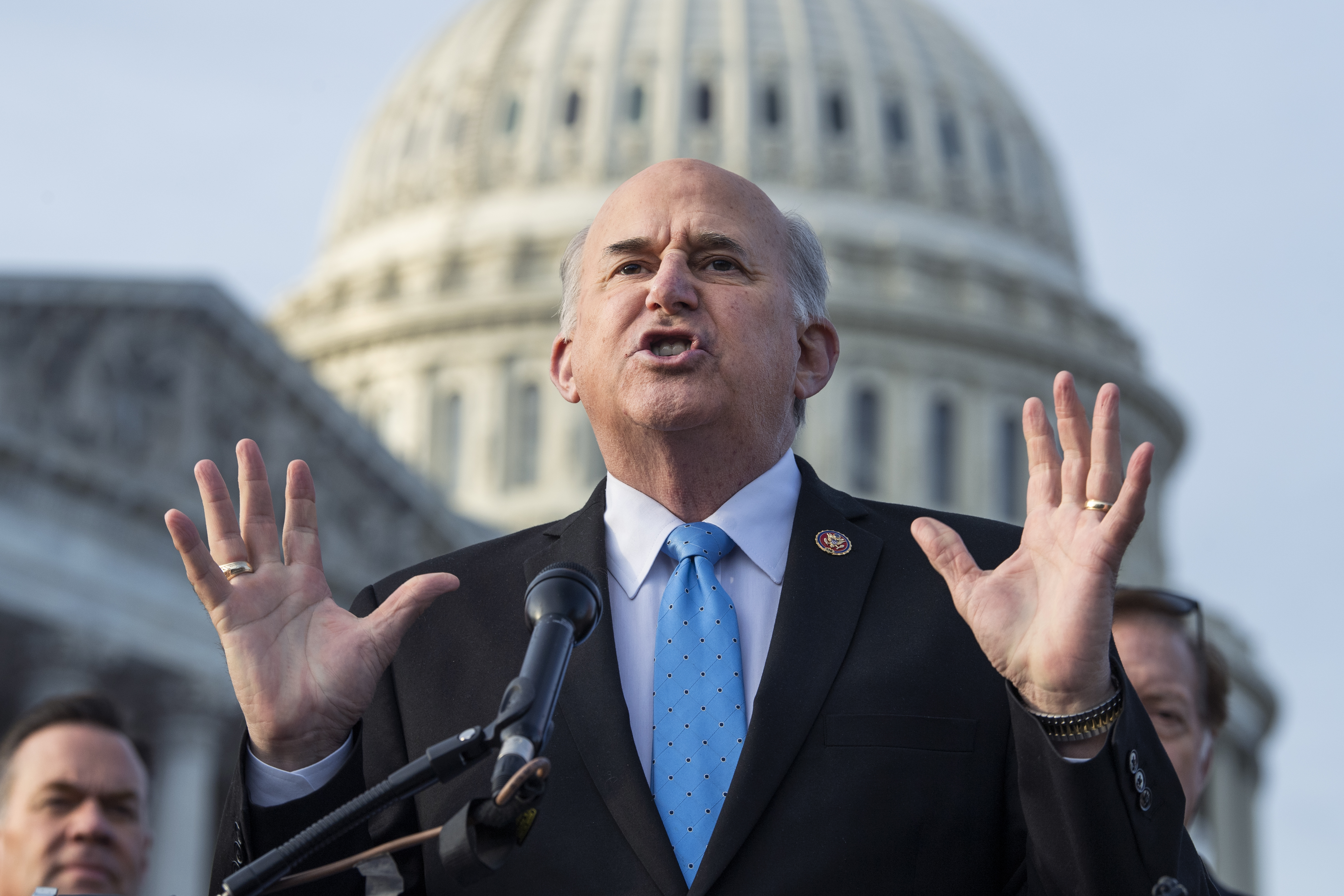 Gohmert, in a dark suit and blue tie, has his head — bald on top, with white hair on the sides — tilted back as he speaks, and framed by the white dome of the Capitol.