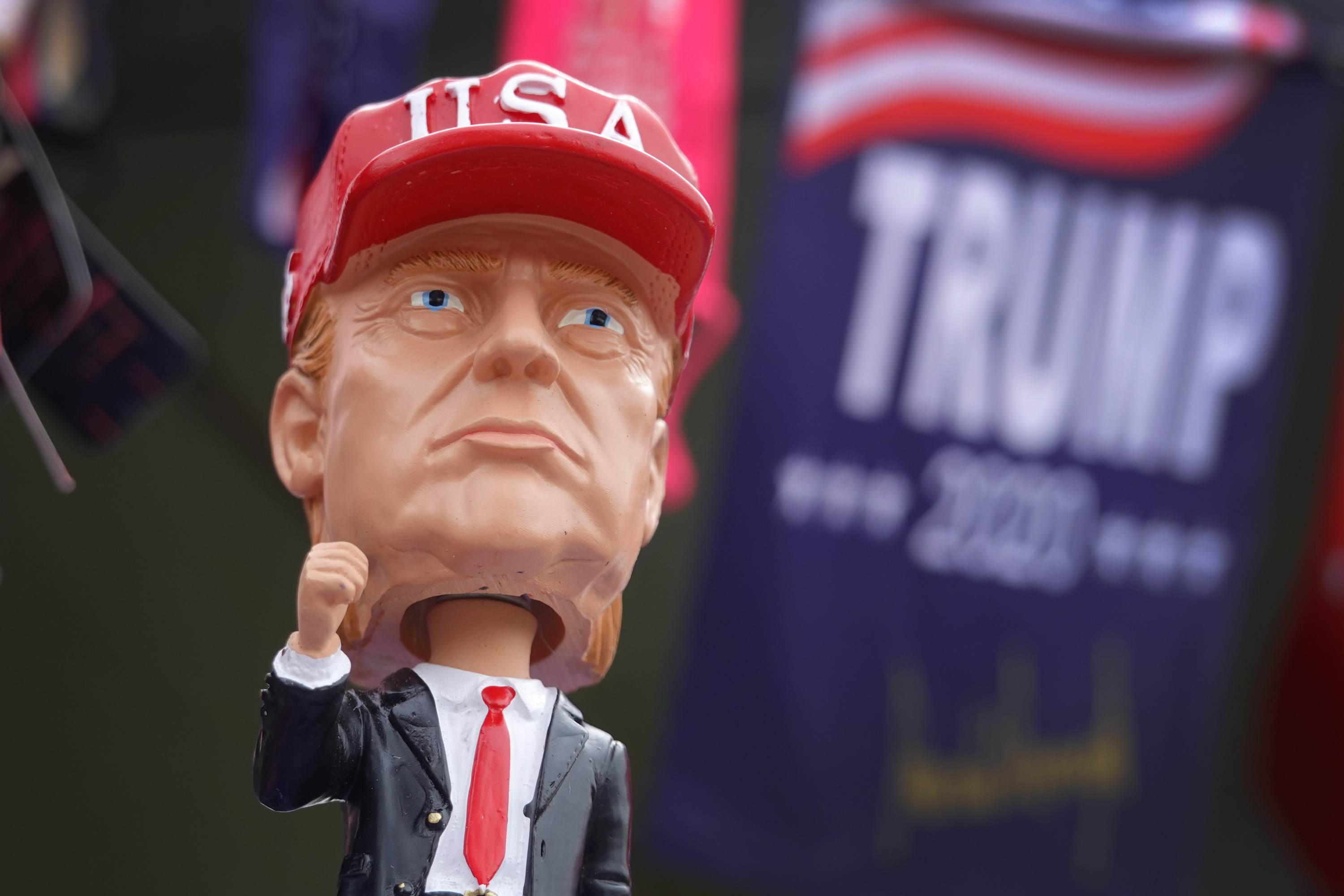 A Trump bobblehead wearing a USA cap.