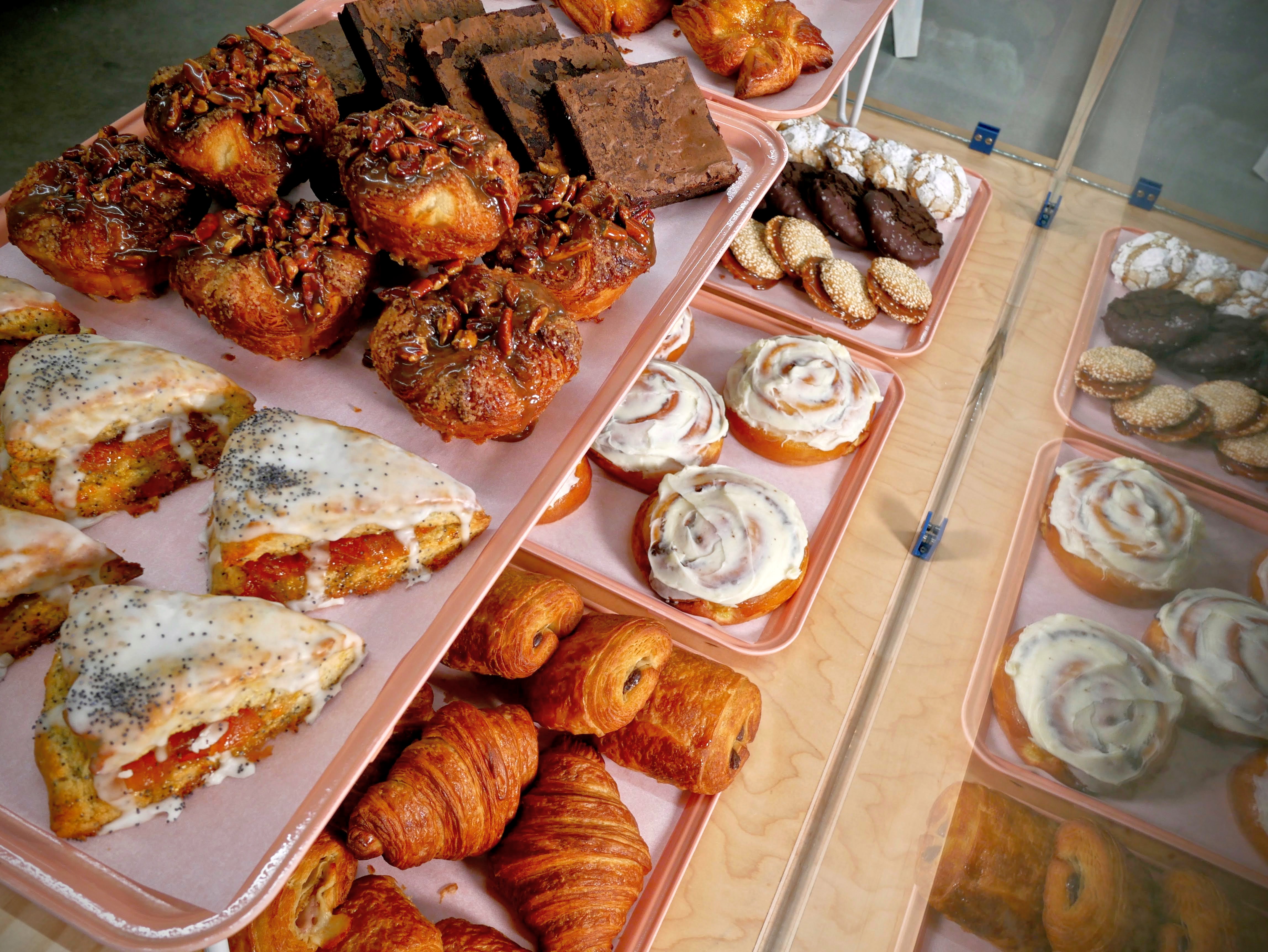 A tiered glass display of various pastries.