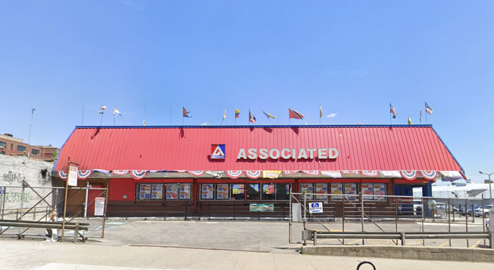 The exterior of the Nostrand Avenue Associated supermarket, which has a red roof