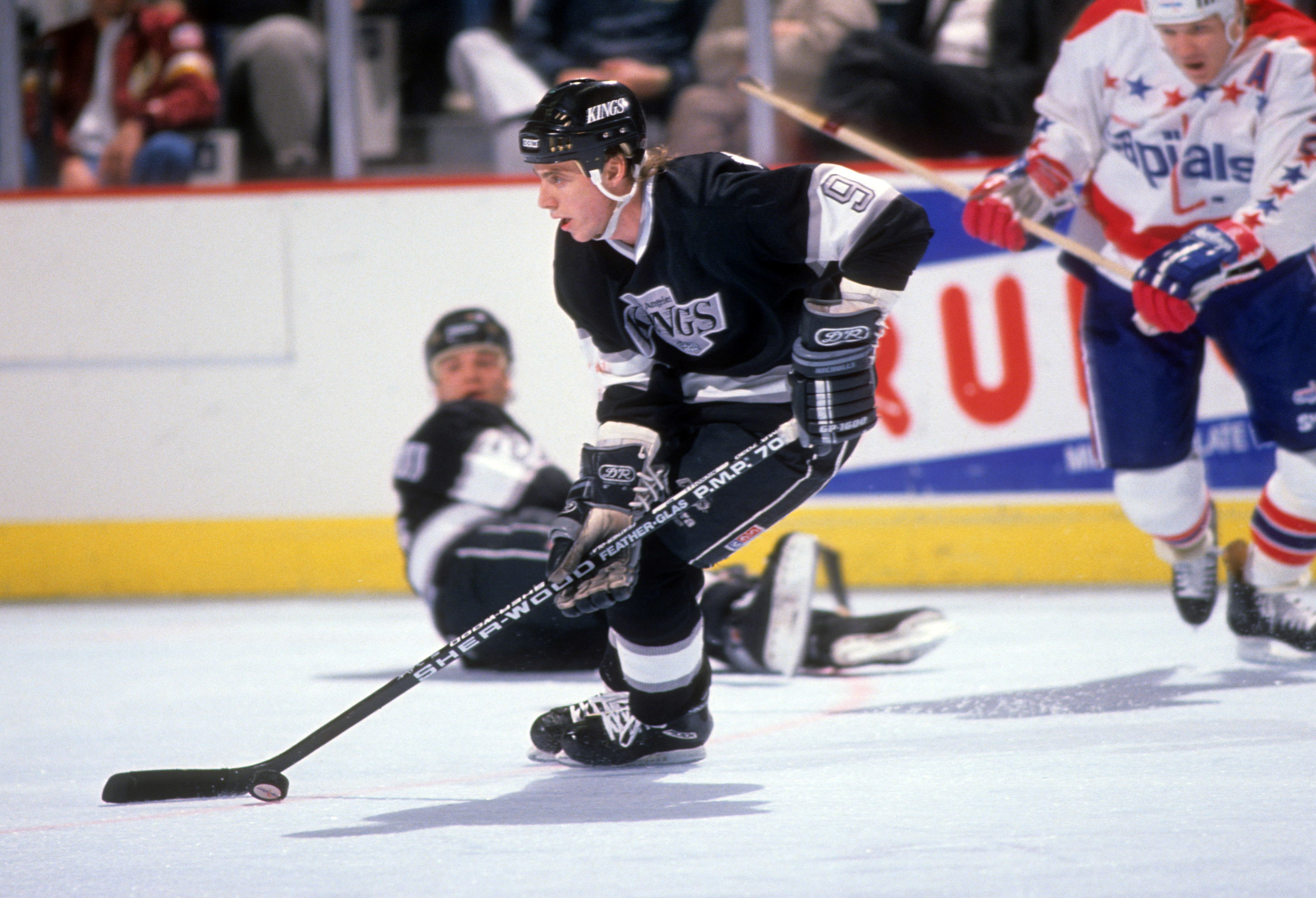 Bernie Nicholls #9 of the Los Angeles Kings skates with the puck during an NHL game against the Washington Capitals on February 10, 1989 at the Capital Centre in Landover, Maryland.
