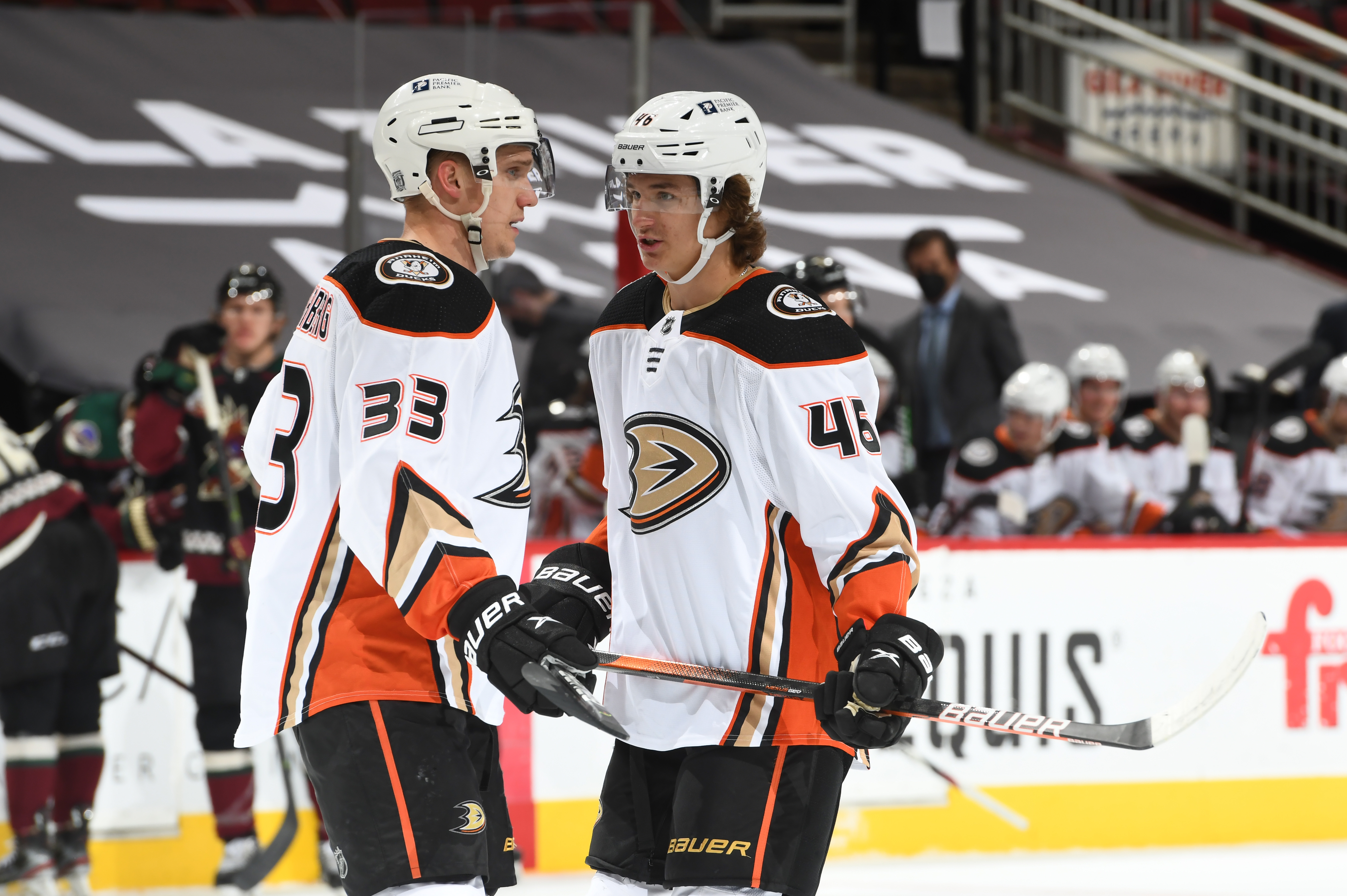 Trevor Zegras #46 of the Anaheim Ducks talks with Jakob Silfverberg #33 prior to a face off against the Arizona Coyotes at Gila River Arena on February 22, 2021 in Glendale, Arizona. The game marked the first career NHL game for Zegras.