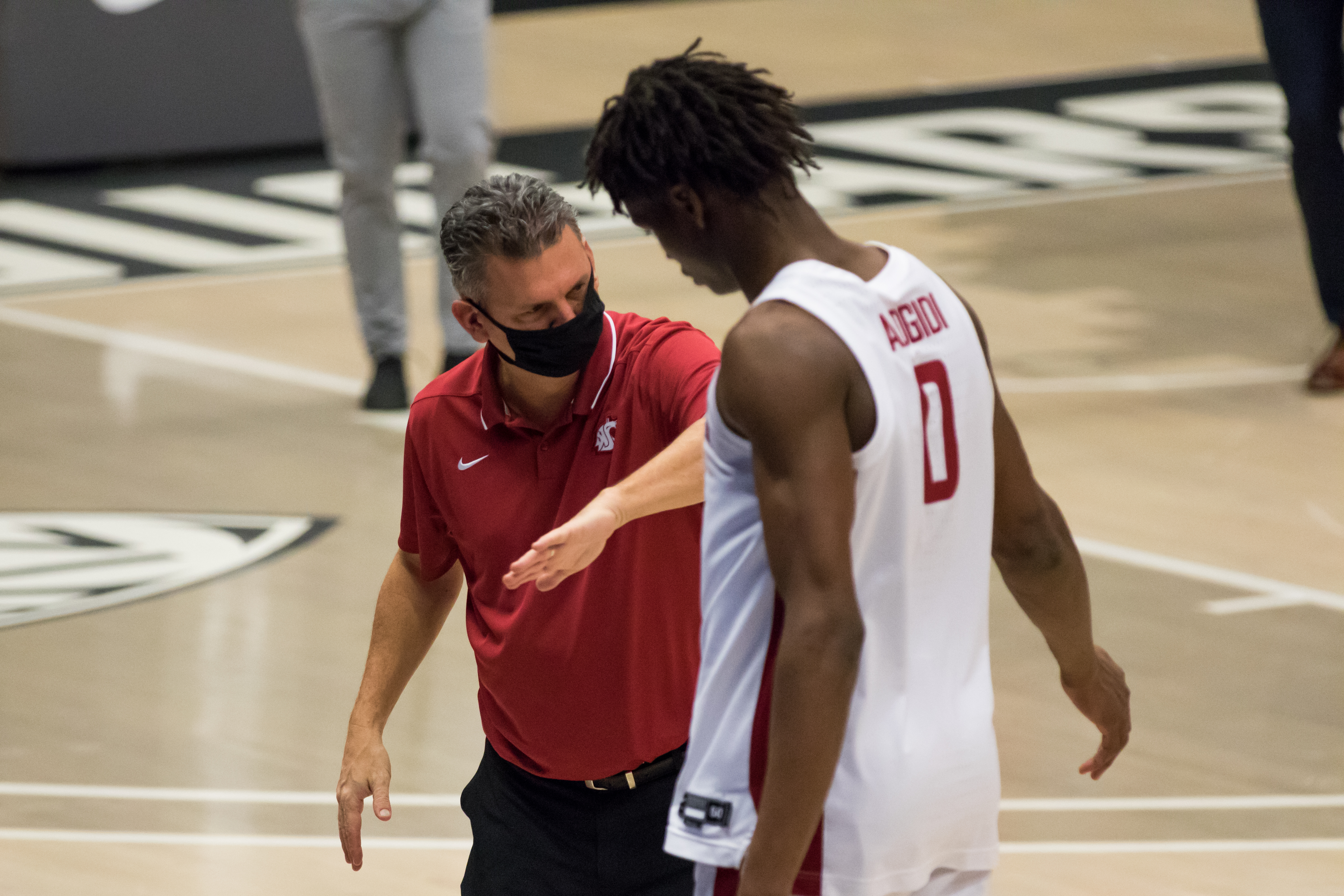 PULLMAN, WA - DECEMBER 18: Washington State head coach Kyle Smith celebrates with center Efe Abogidi (0) prior to a non-conference matchup between the Montana State Bobcats and the Washington State Cougars on December 18, 2020, at Beasley Coliseum in Pullman, WA.