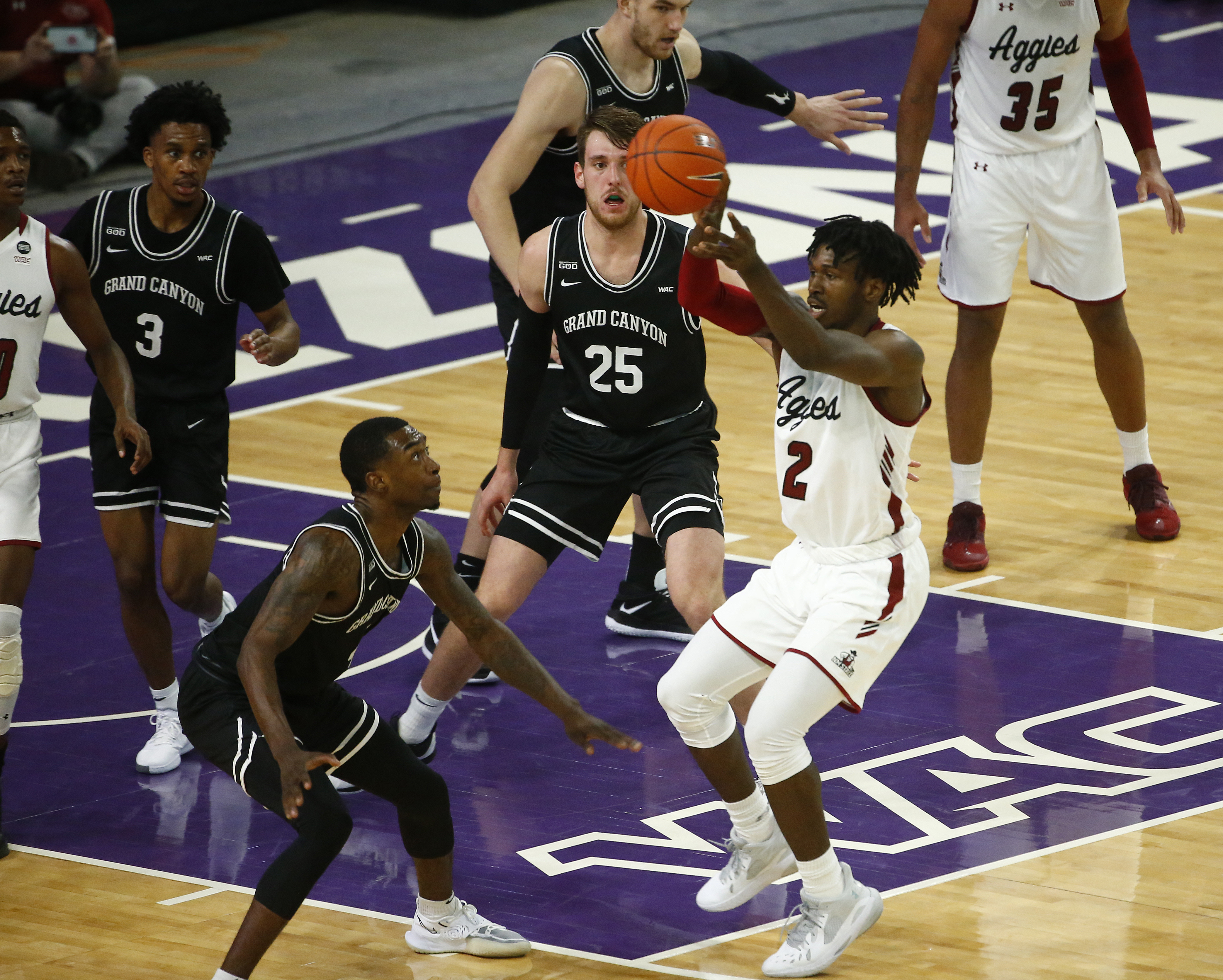 New Mexico State Aggies forward Donnie Tillman passes the ball against Grand Canyon Antelopes forward Oscar Frayer during the second half at GCU Arena.&nbsp;
