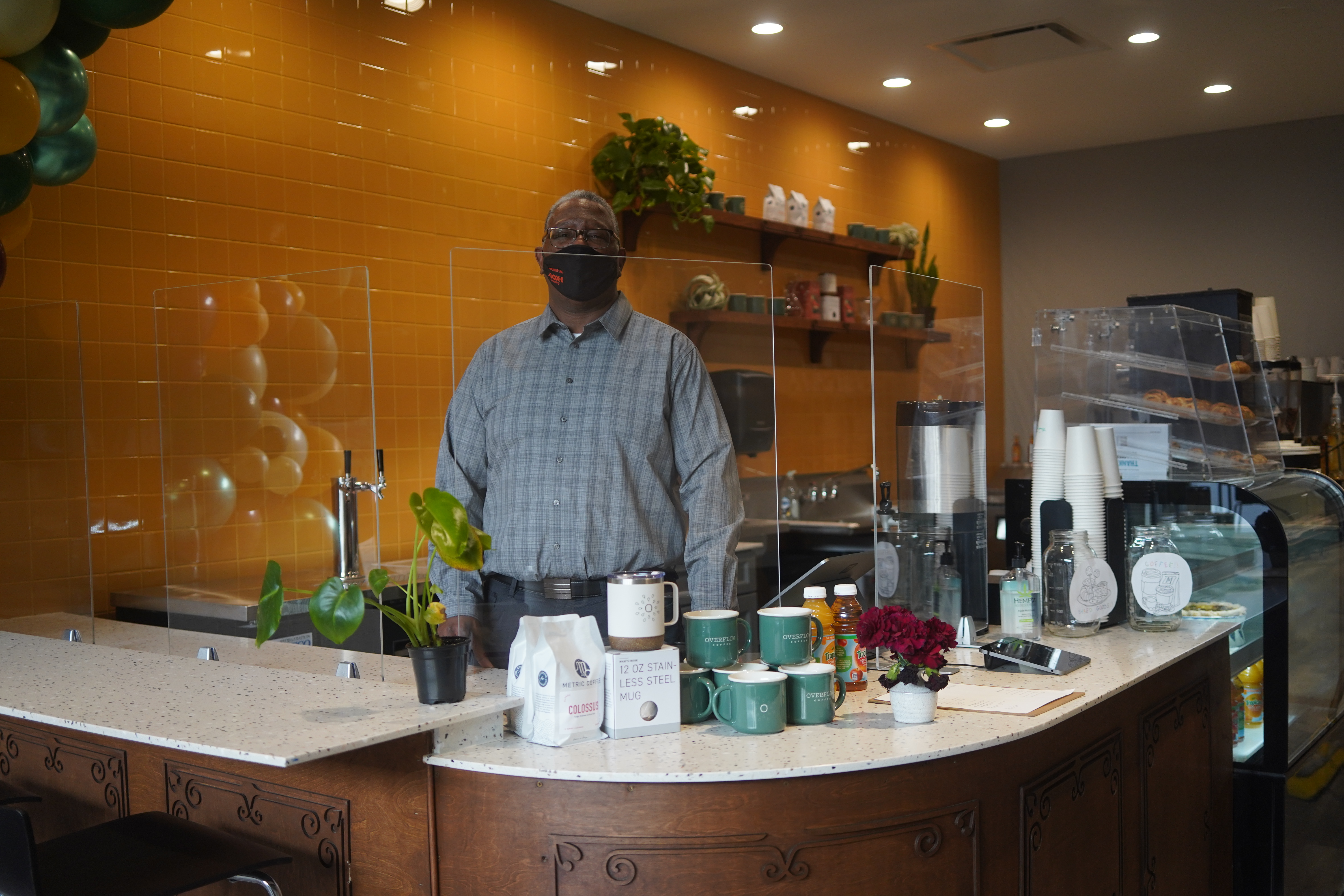 L. Brian Jenkins stands in his new Overflow Coffee underneath his co-working space Mox.E, at 1449 S. Michigan Ave.