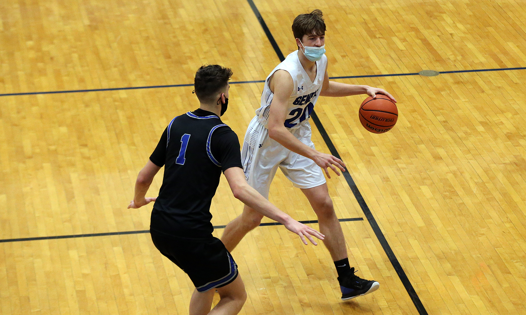 Geneva’s Ryan Huskey (20) controls the ball as St. Charles North’s Ethan Marlowe defends.