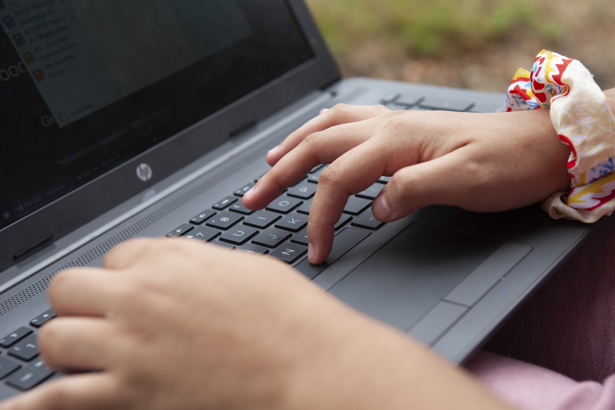 Close up of a student’s hands typing on a laptop.