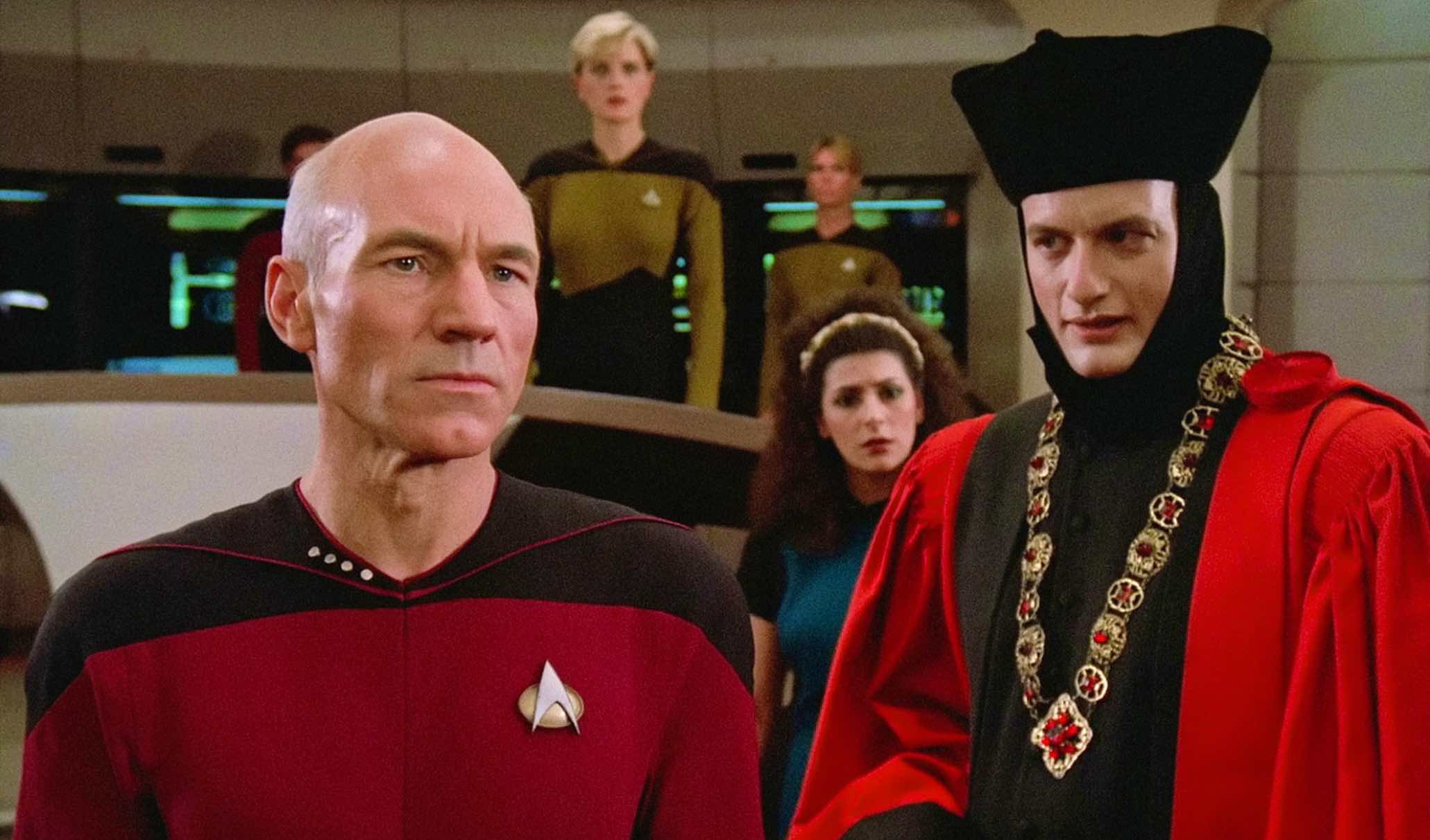 John de Lancie in his judge costume from the Star Trek: The Next Generation episode “Encounter at Farpoint” faces Jean-Luc Picard