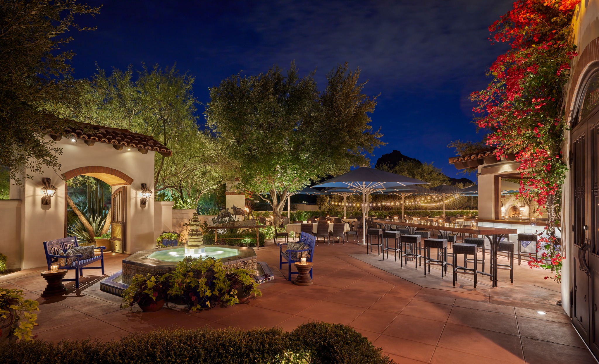 An evening shot of the patio at El Chorro with a water feature and tables.