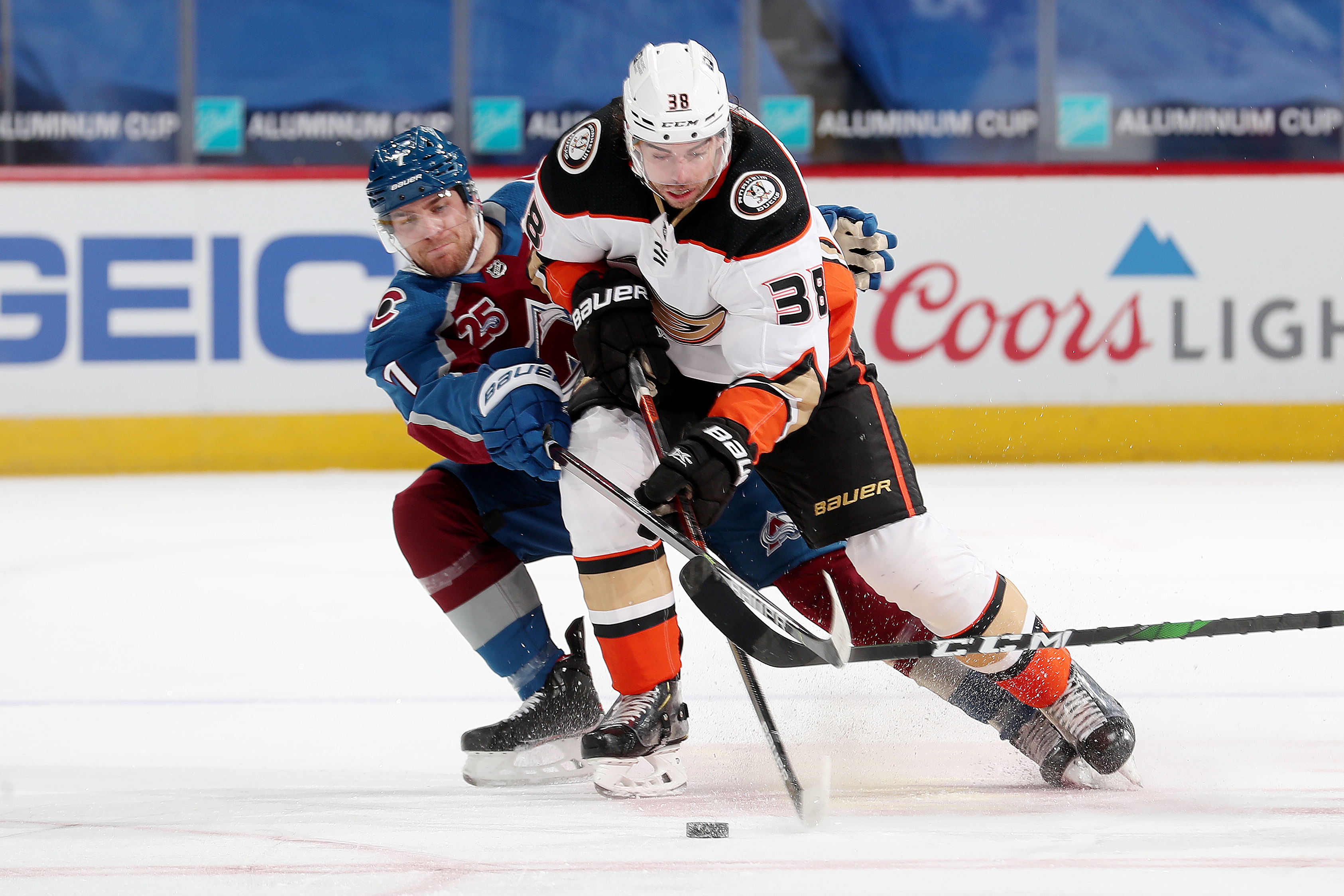 Derek Grant #38 of the Anaheim Ducks battles for position against Devon Toews #7 of the Colorado Avalanche at Ball Arena on March 29, 2021 in Denver, Colorado.