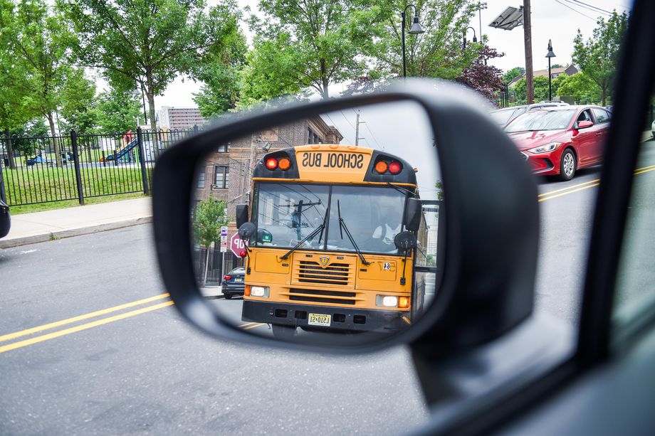 School bus shown in the rear-view mirror of a vehicle.