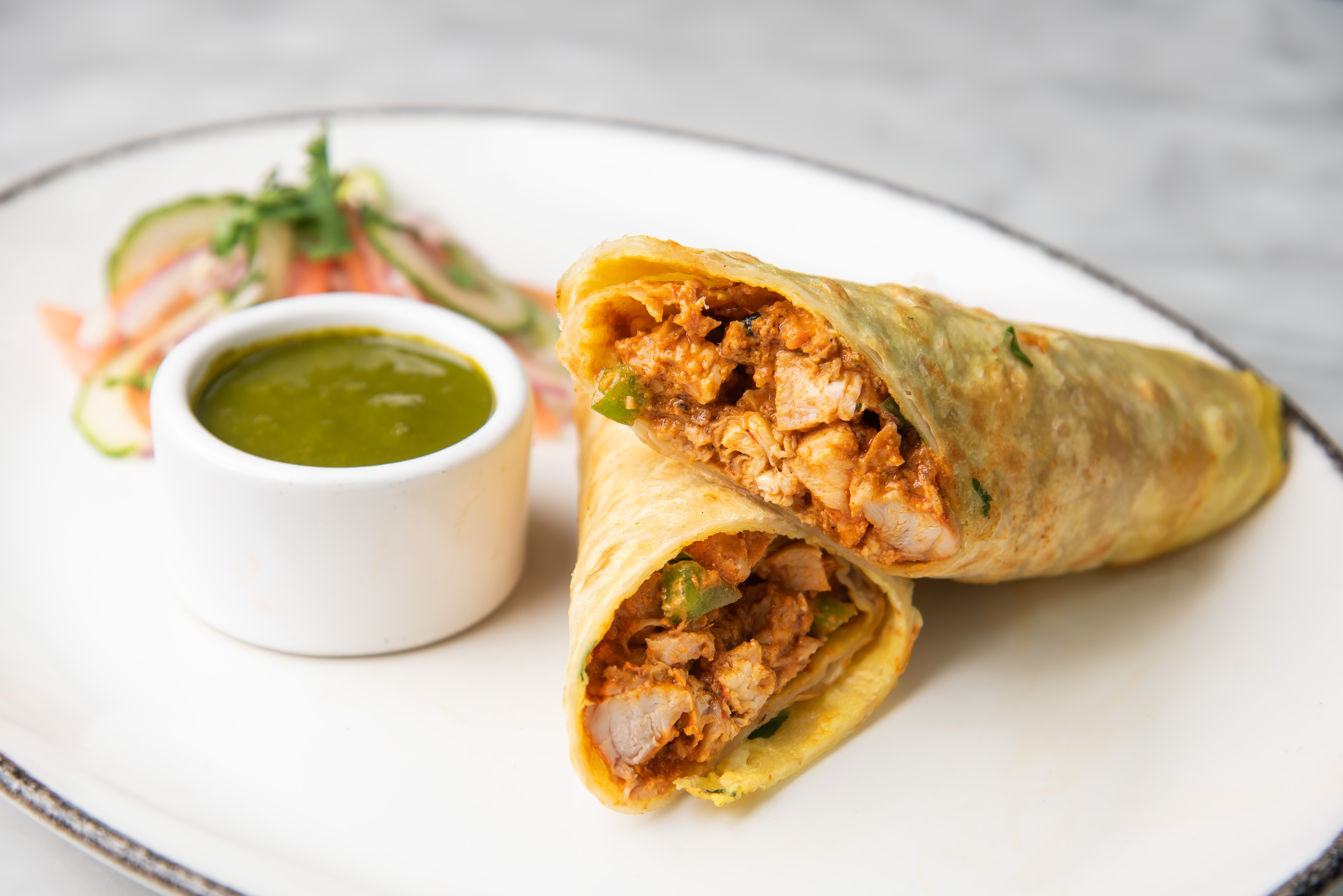 A chicken kathi roll with mint cilantro chutney will be at the new Bindaas location