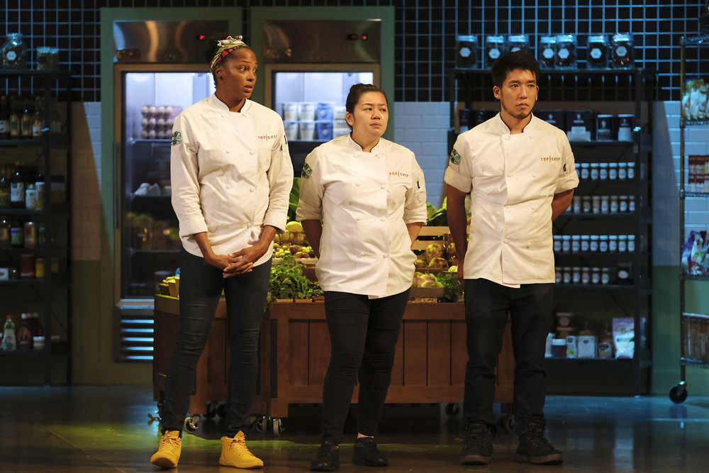 Three chefs stand in a row