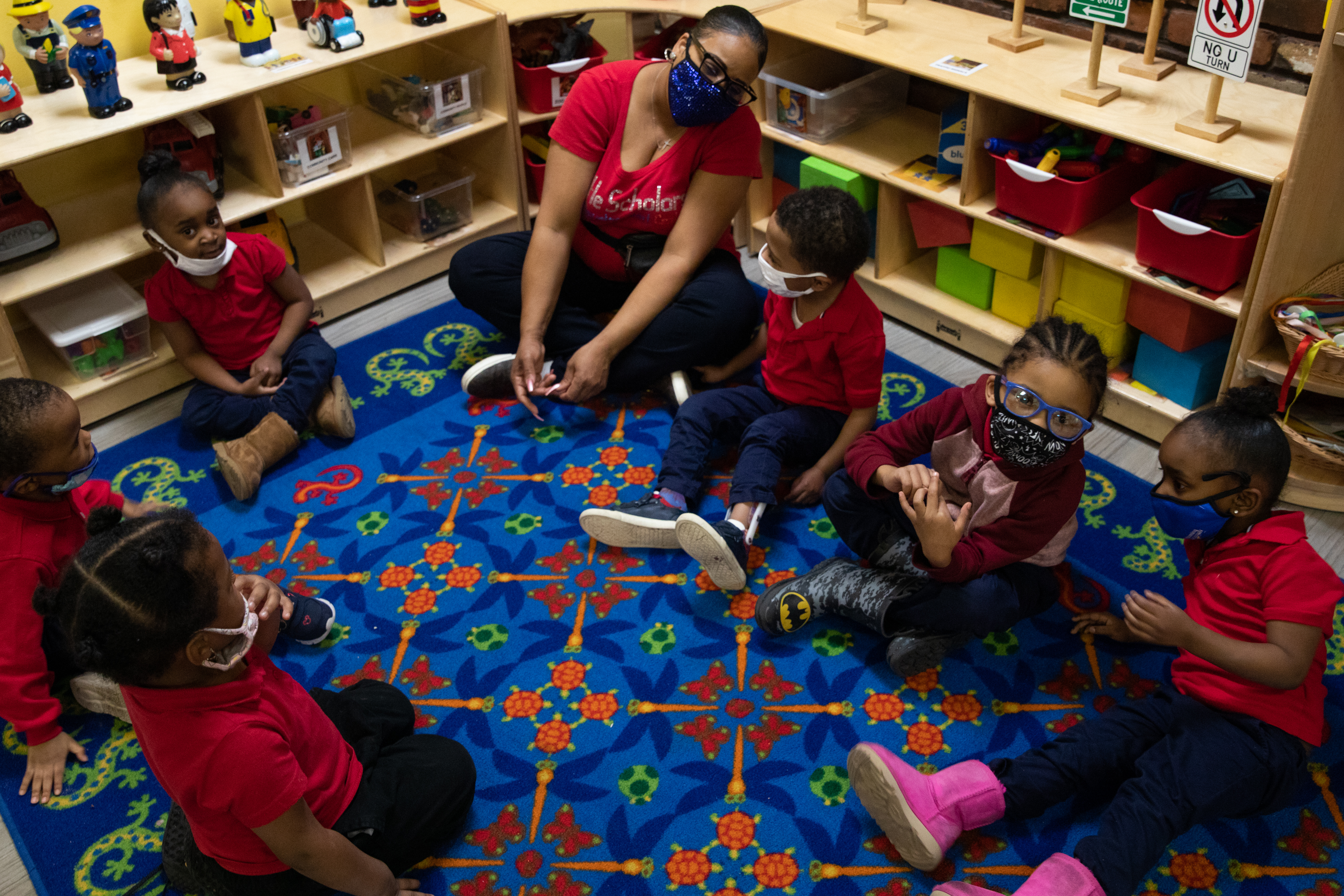 Preschoolers sit in a circle as they participate in morning exercises at Little Scholars child care center in Detroit, Michigan, U.S., on Thursday April 1, 2021.