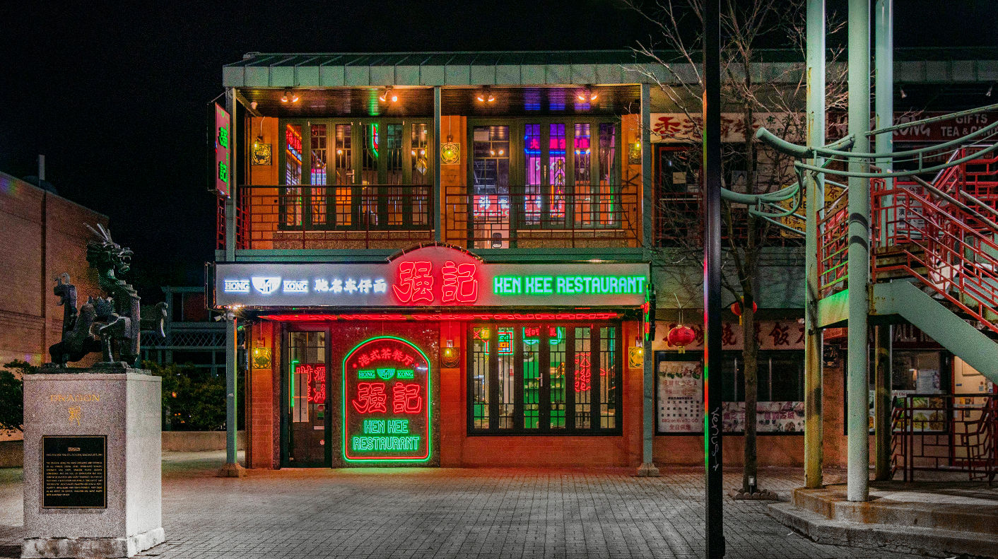 A neon-lit two-story restaurant.