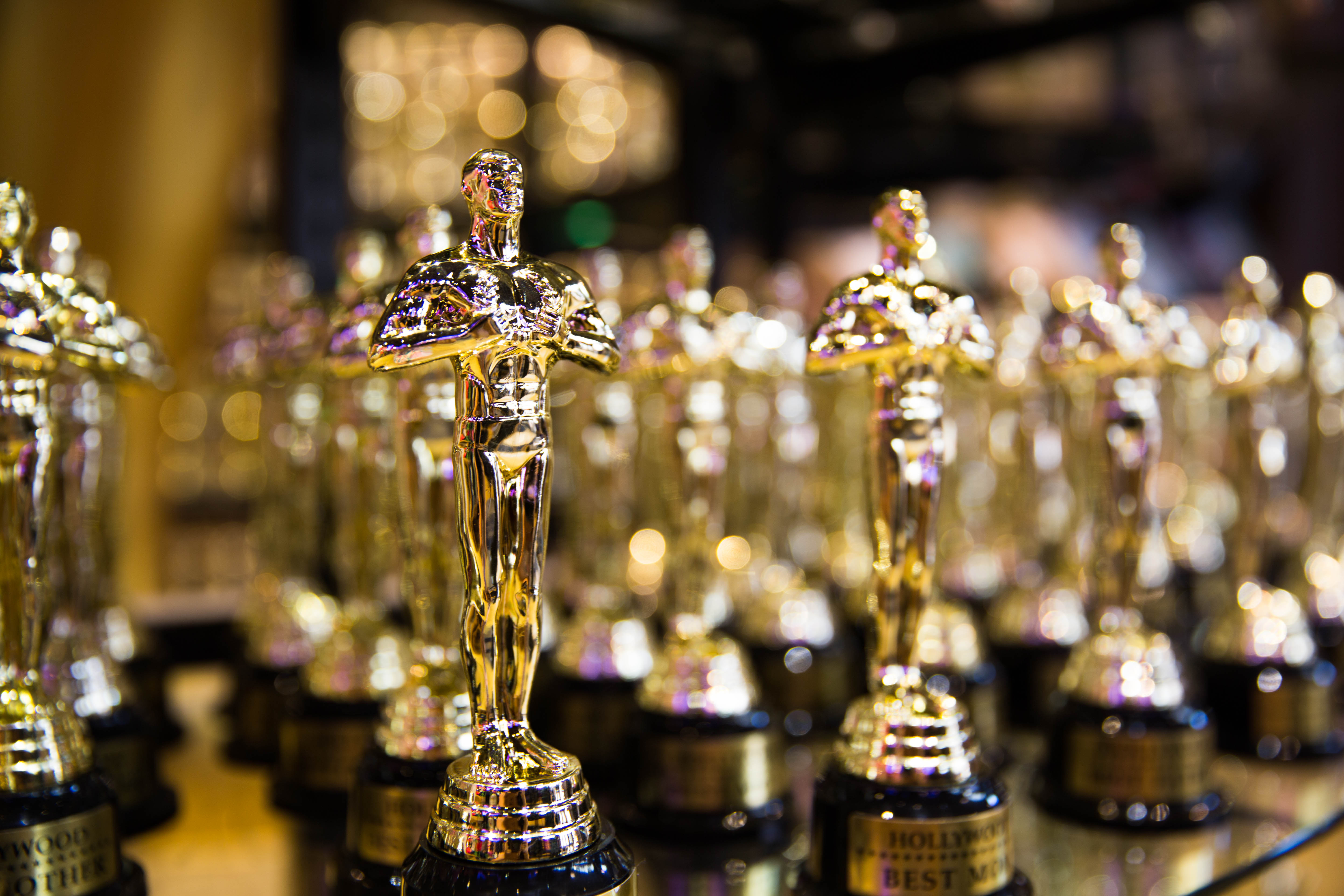 Multiple rows of golden Academy Awards trophies, shown close up