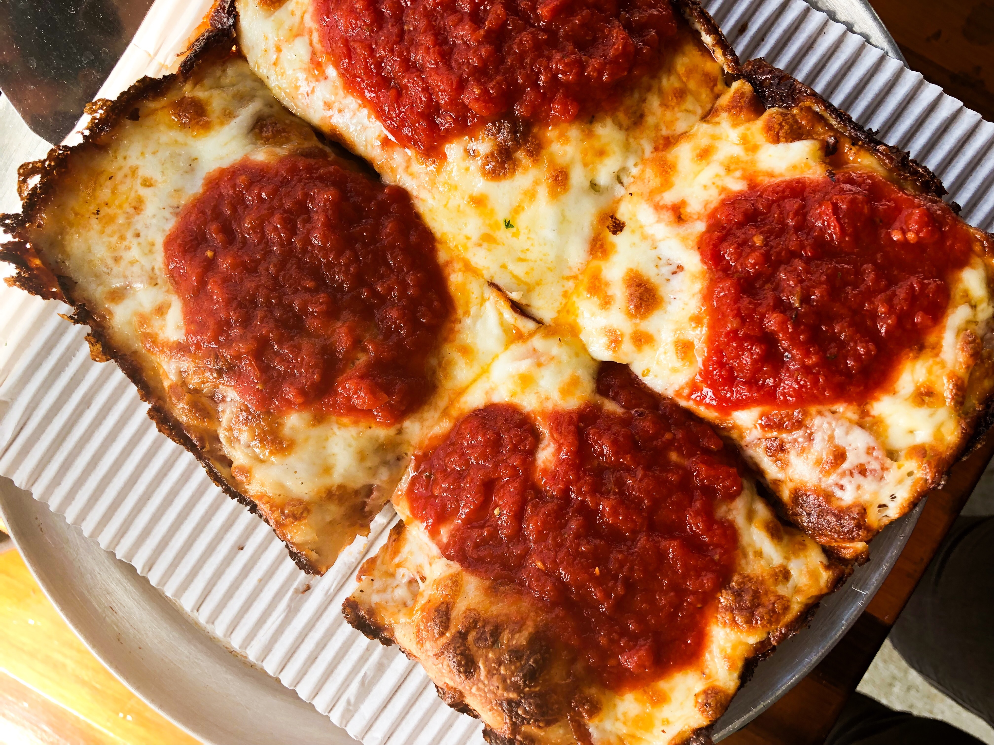 A Detroit-style pizza from Assembly Brewing, with dollops of brick-red tomato sauce.