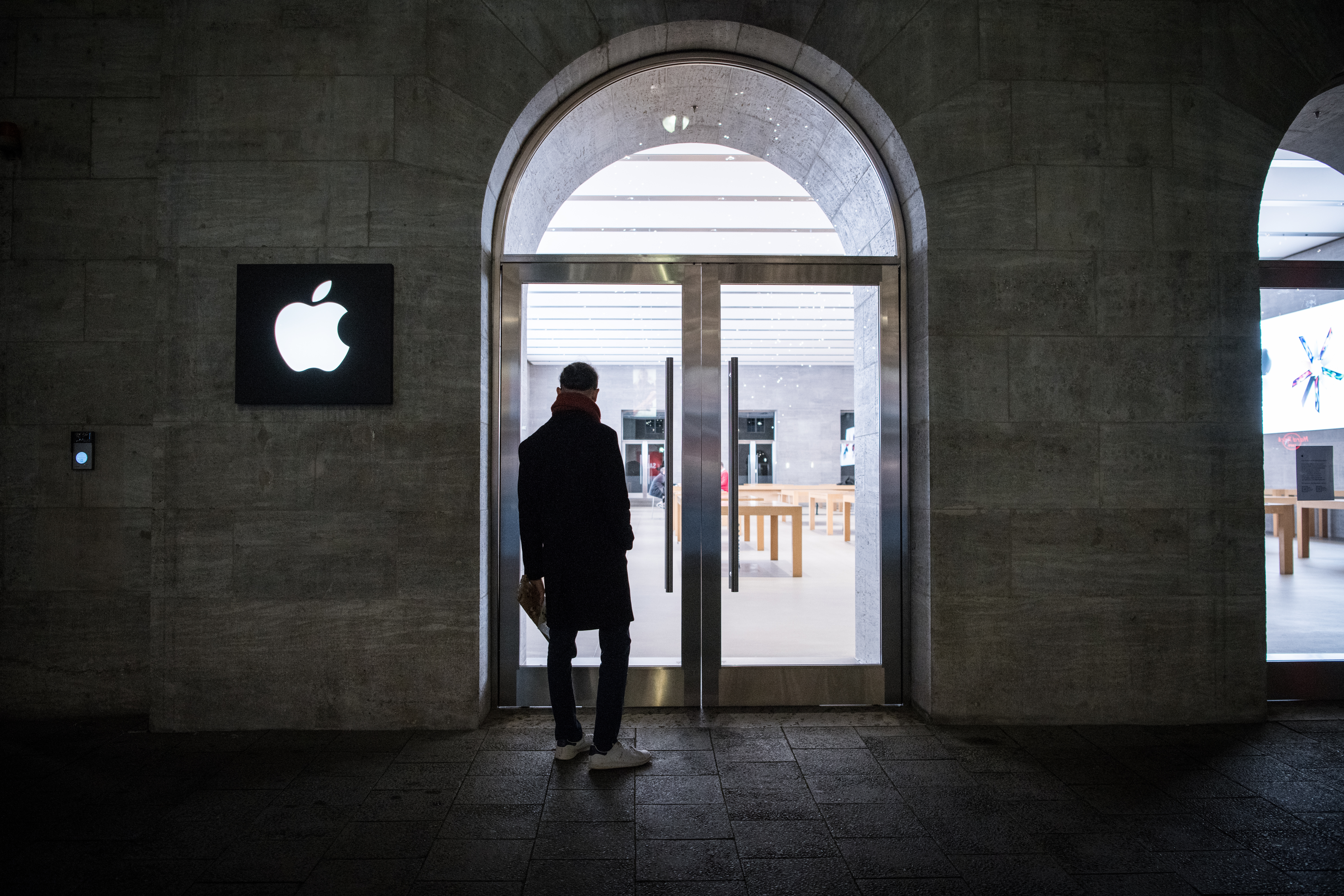 A man stands in front of an Apple store in Berlin, Germany, in December 2020.