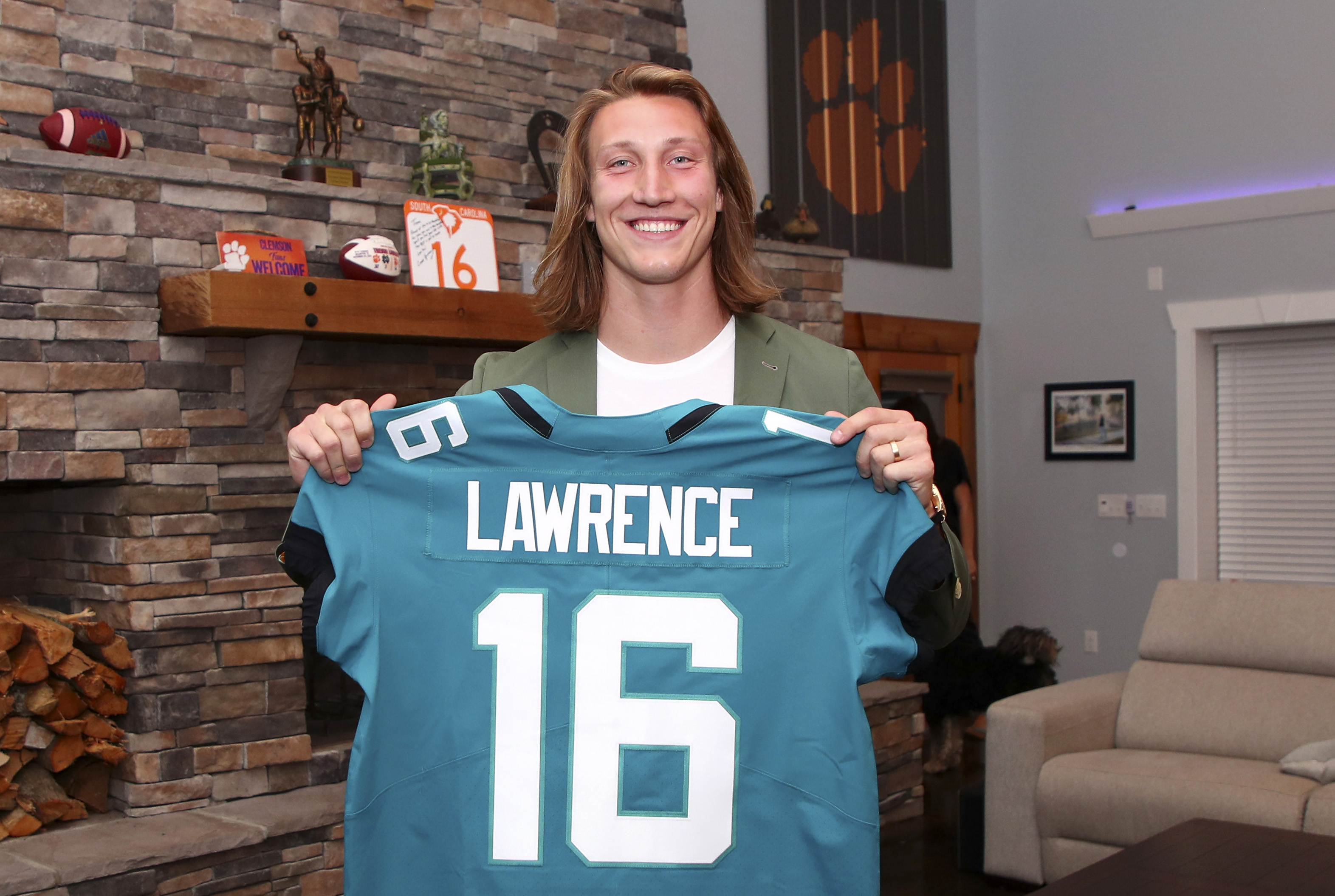 In this handout photo provided by the National Football League, quarterback Trevor Lawrence poses after being selected with the first overall pick by the Jacksonville Jaguars in the 2021 NFL Draft on April 29, 2021 in Seneca, South Carolina.
