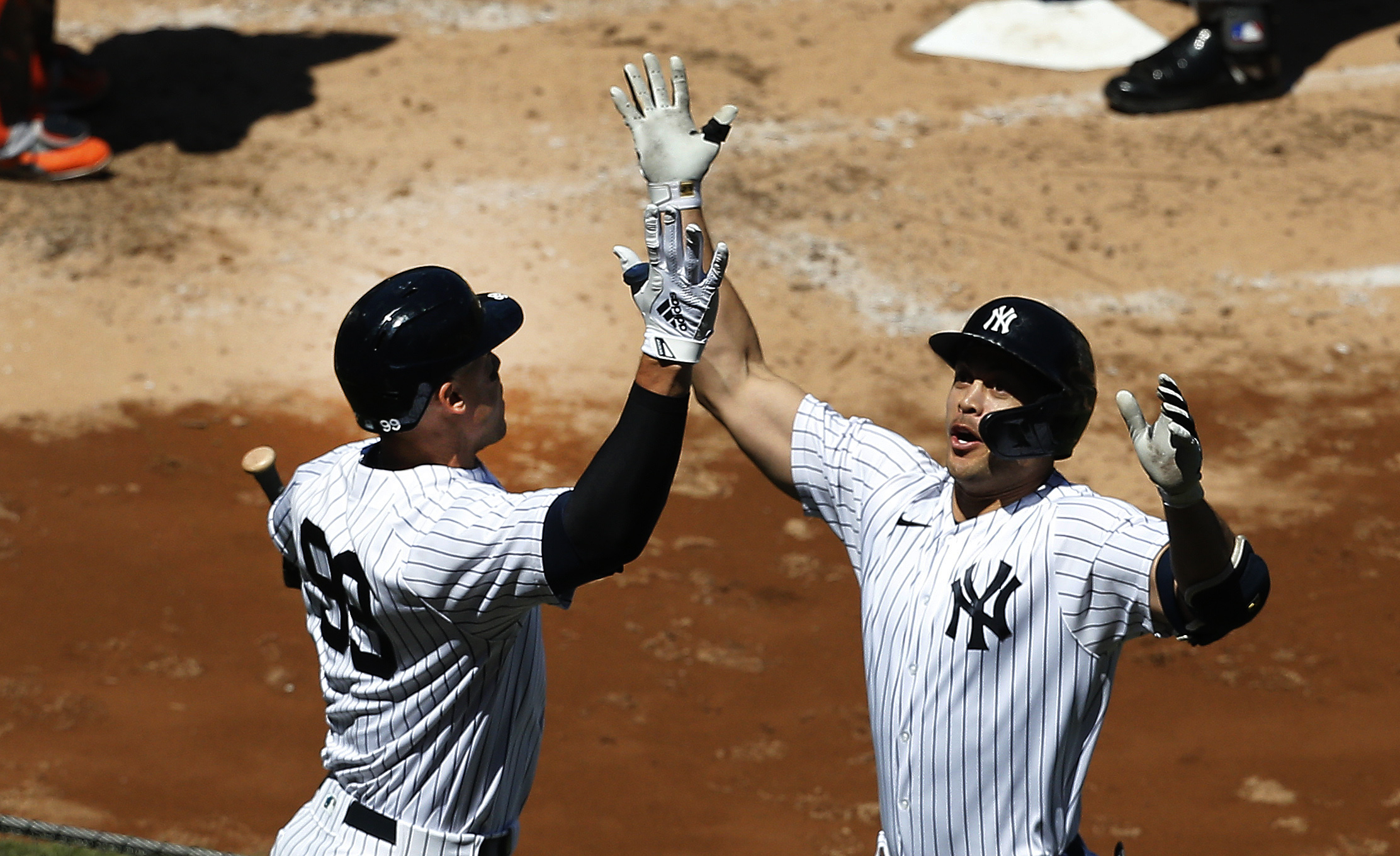 New York Yankees designated hitter Giancarlo Stanton is congratulated by right fielder Aaron Judge after hitting a solo home run against the Houston Astros during the third inning at Yankee Stadium.