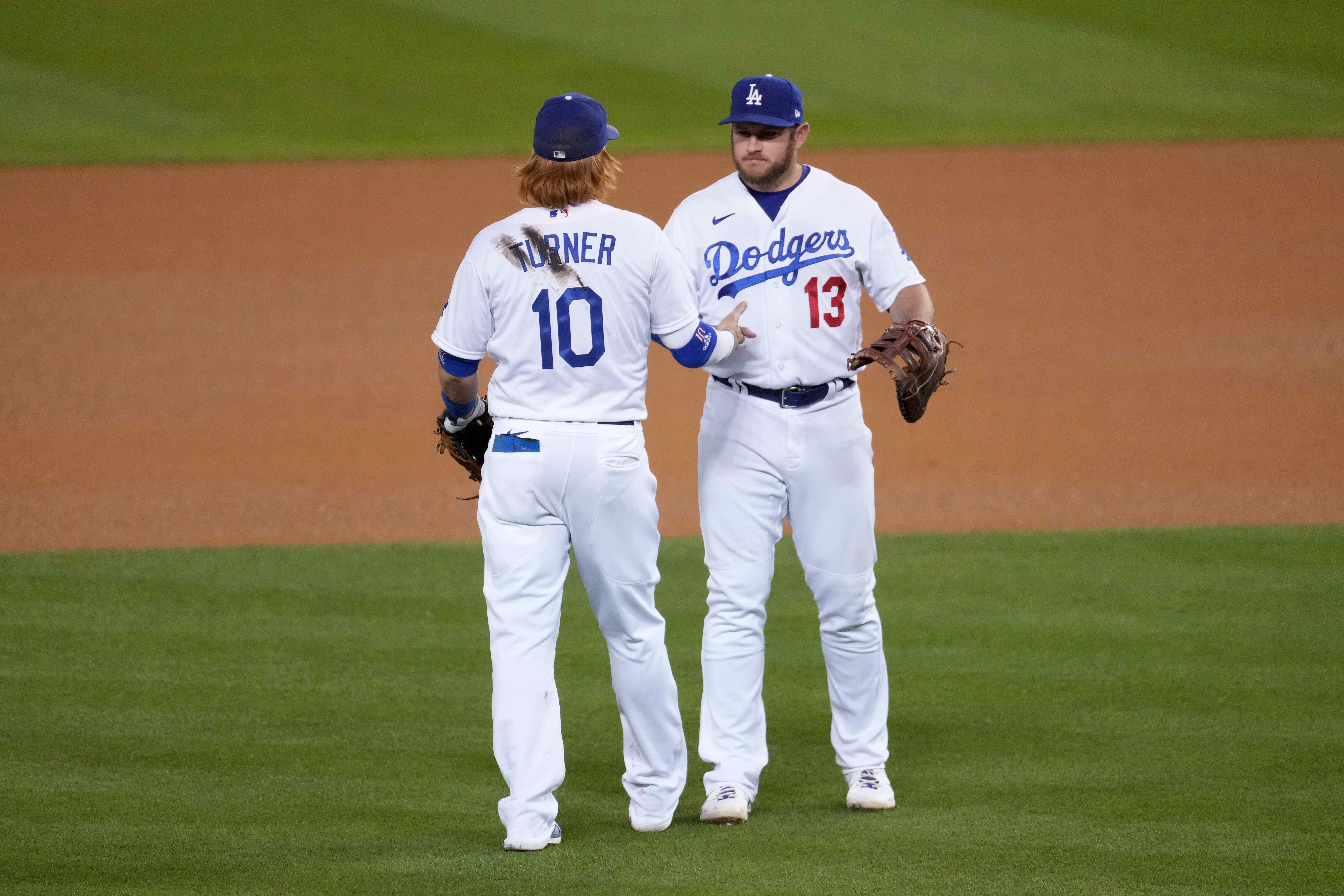 Los Angeles Dodgers third baseman Justin Turner and first baseman Max Muncy celebrate after the game against the Seattle Mariners at Dodger Stadium.