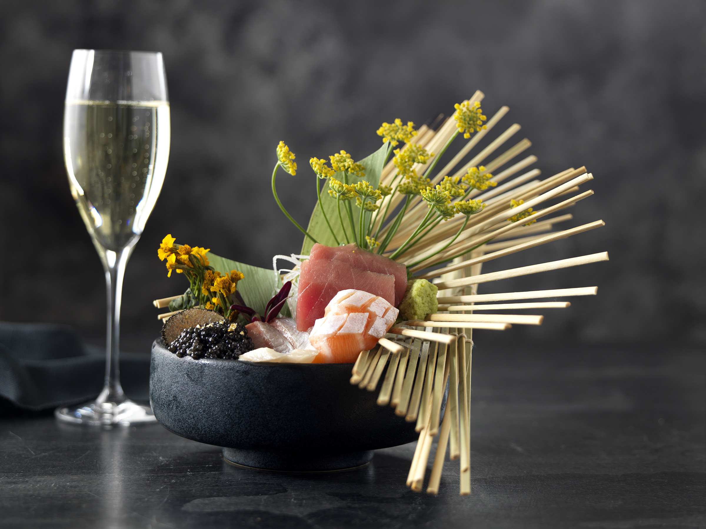 A display of sashimi and a glass of champagne