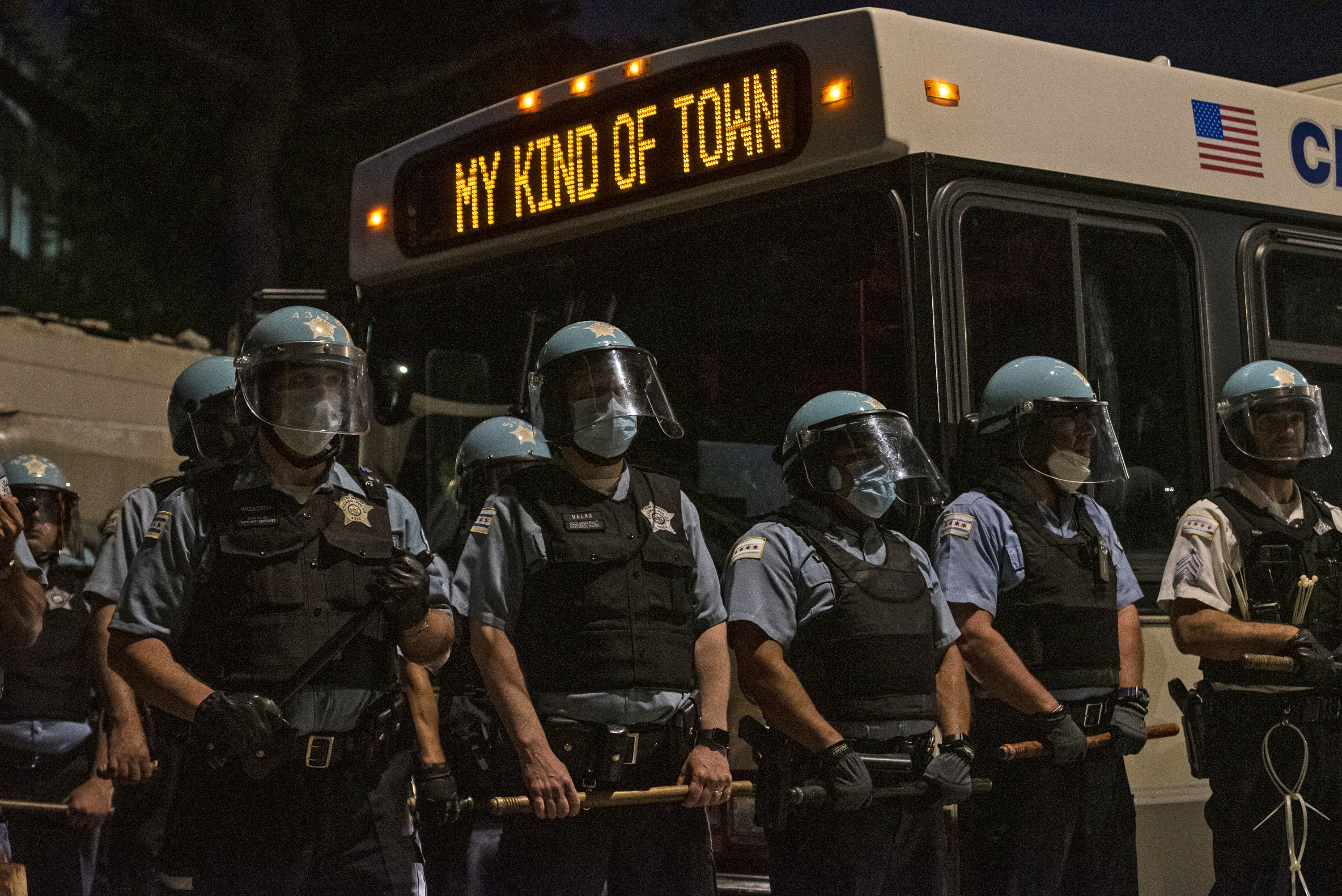 Chicago police officers block Michigan Avenue at 36th Street, using a CTA bus and their bodies while protesters march toward Chicago police headquarters on June 4, 2020.