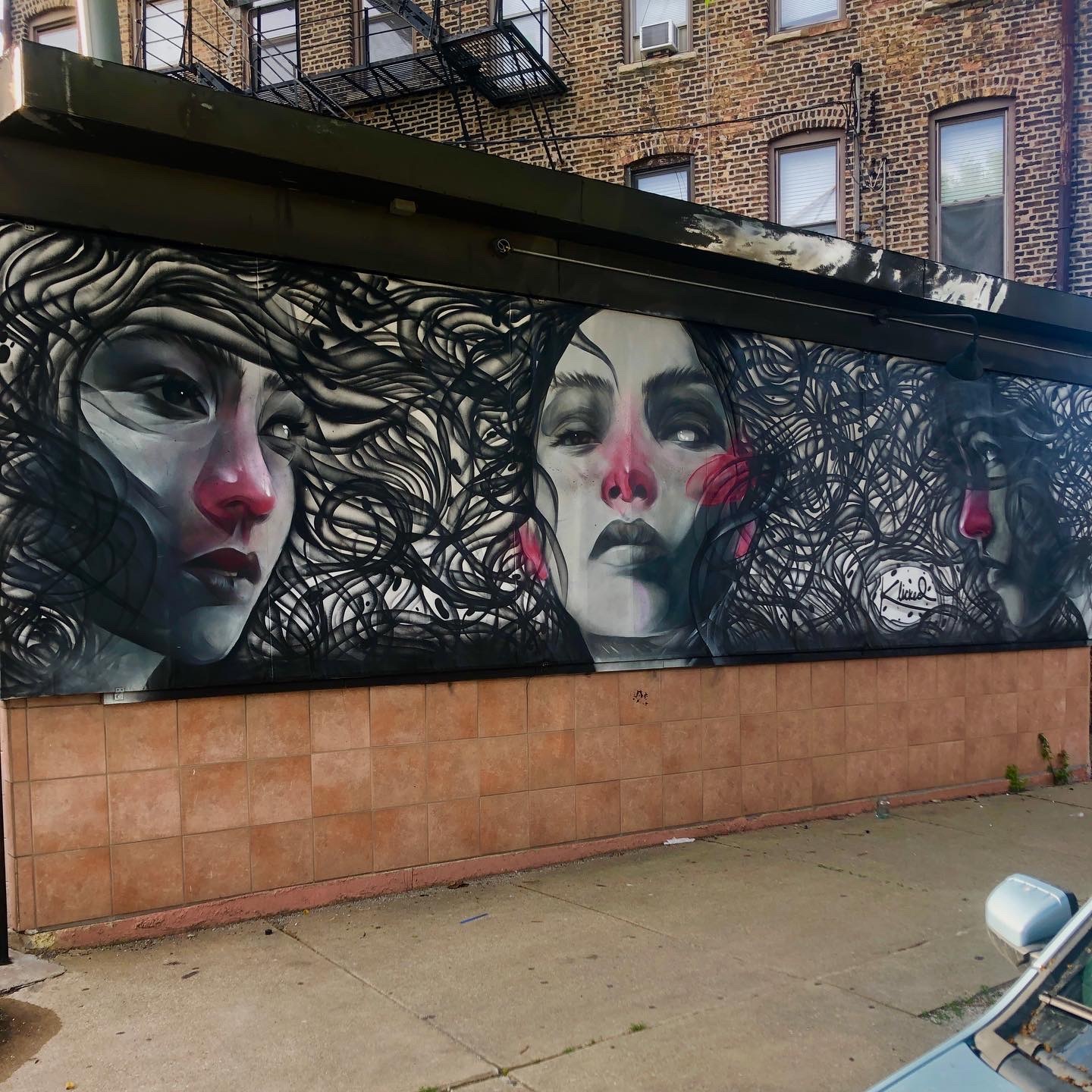 Artists Won Kim and rawooh collaborated on this mural at Klicked Salon on the Near West Side that combines realistic portraits with abstract hair designs.
