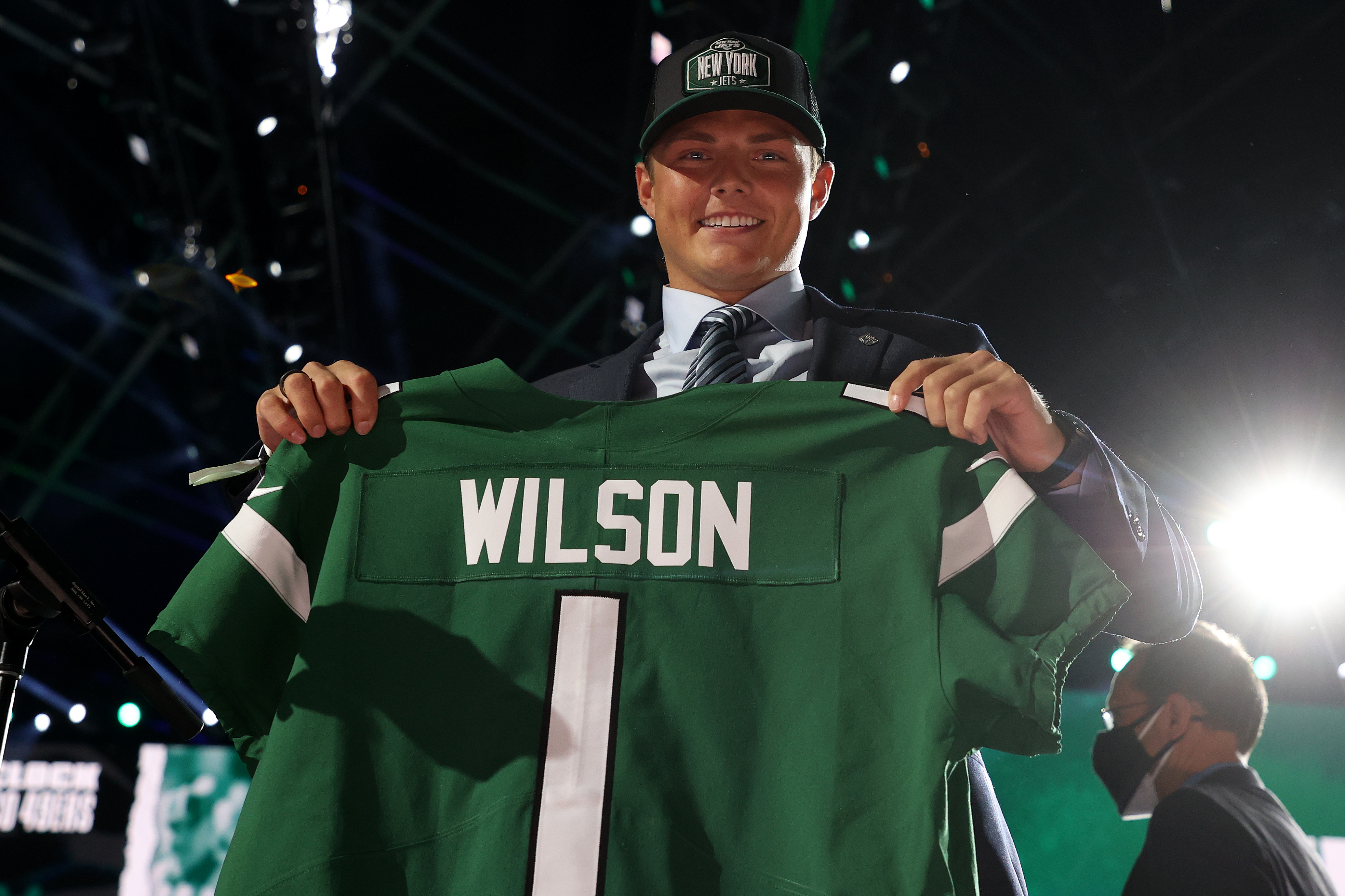 Zach Wilson holds a jersey onstage after being drafted second by the New York Jets during round one of the 2021 NFL Draft at the Great Lakes Science Center on April 29, 2021 in Cleveland, Ohio.