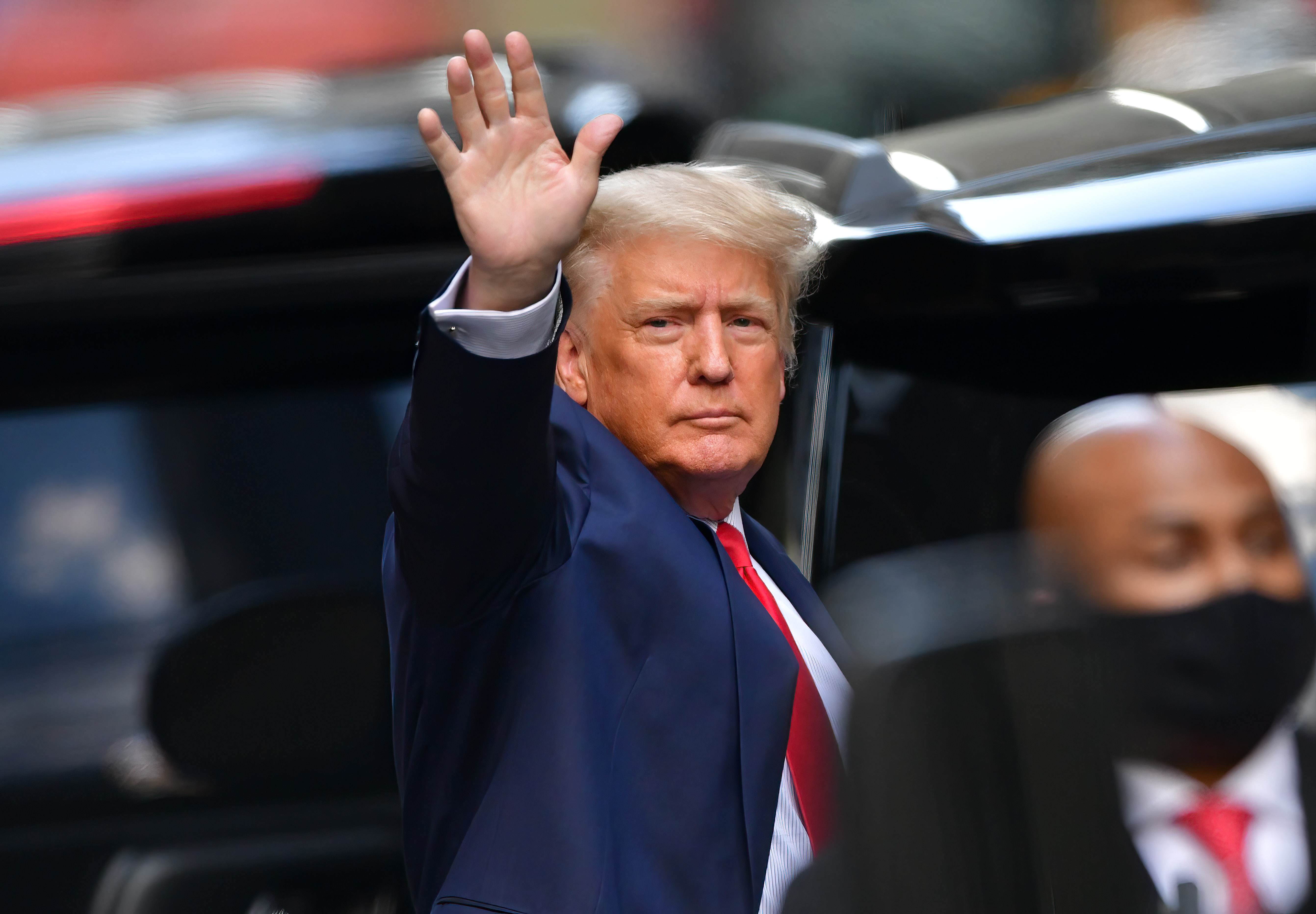 Former president Donald Trump waves as he heads toward his car after exiting Trump Tower in Manhattan on May 18, 2021, in New York City.