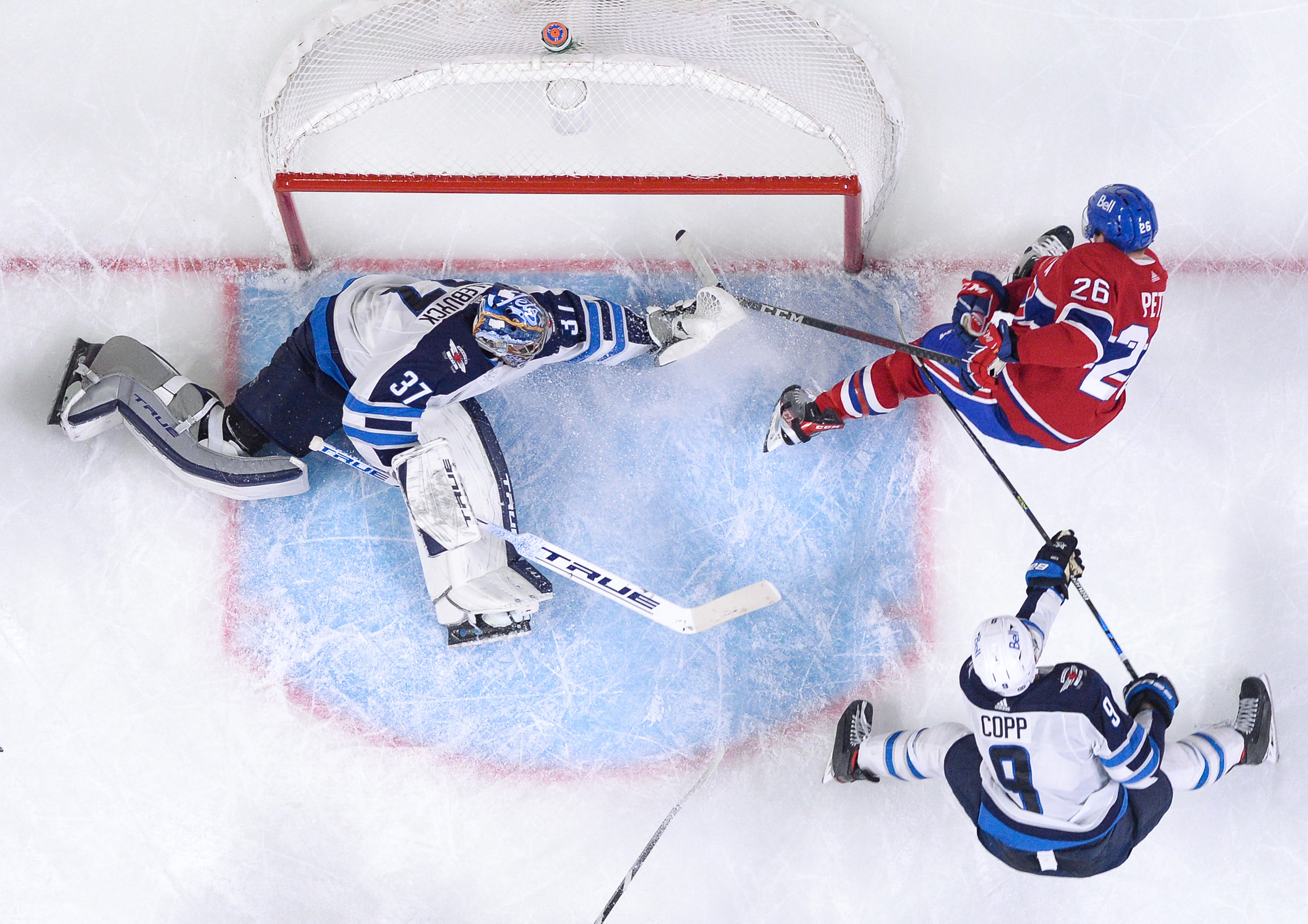 Connor Hellebuyck #37 of the Winnipeg Jets defends the goal against Jeff Petry #26 of the Montreal Canadiens in the NHL game at the Bell Centre on April 30, 2021 in Montreal, Quebec, Canada.