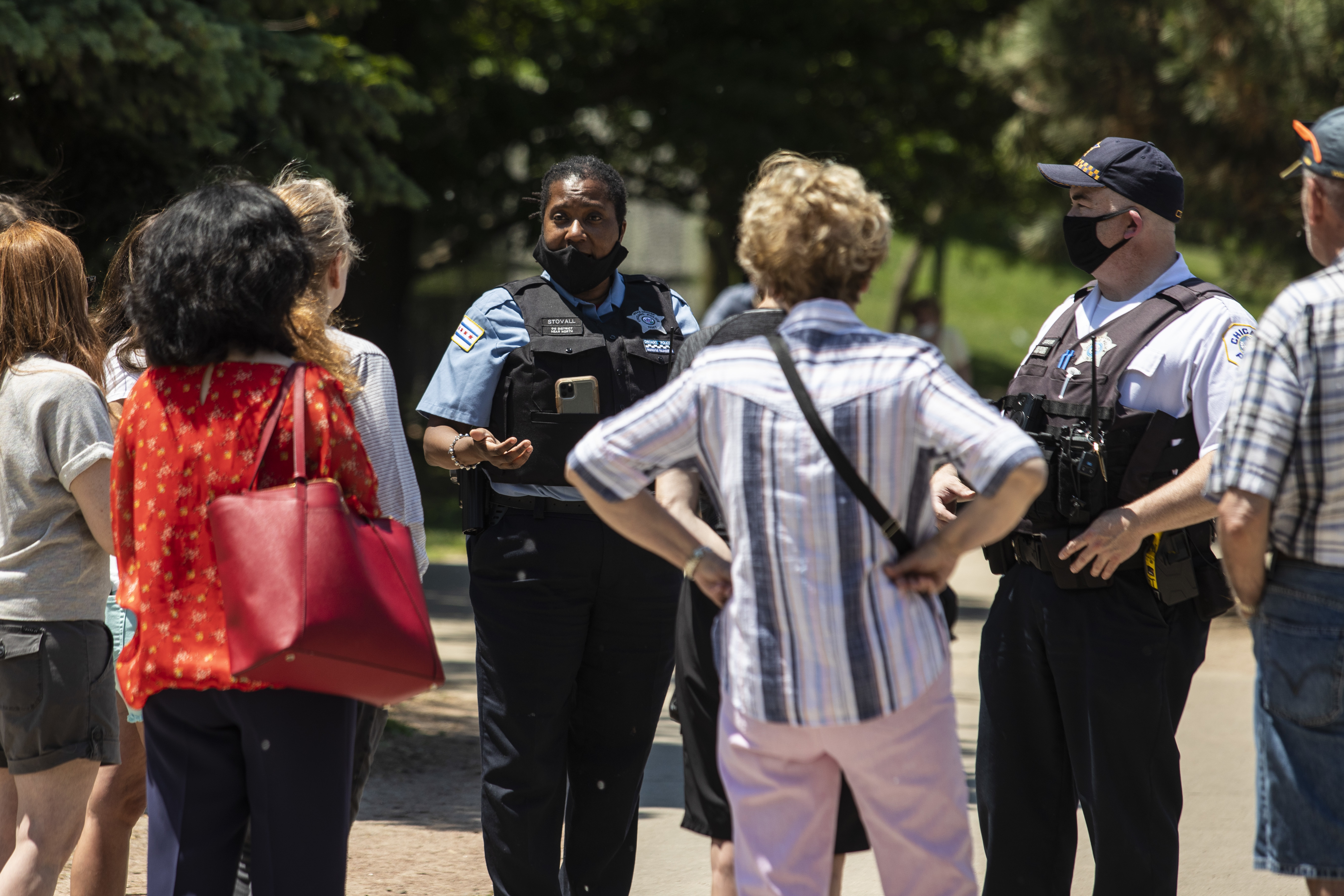Chicago Police Officer Ramona Stovall and Sgt. Christopher Schenk speak to residents during a community meeting Friday afternoon about public safety and policing near Oz Park in Lincoln Park on the North Side.