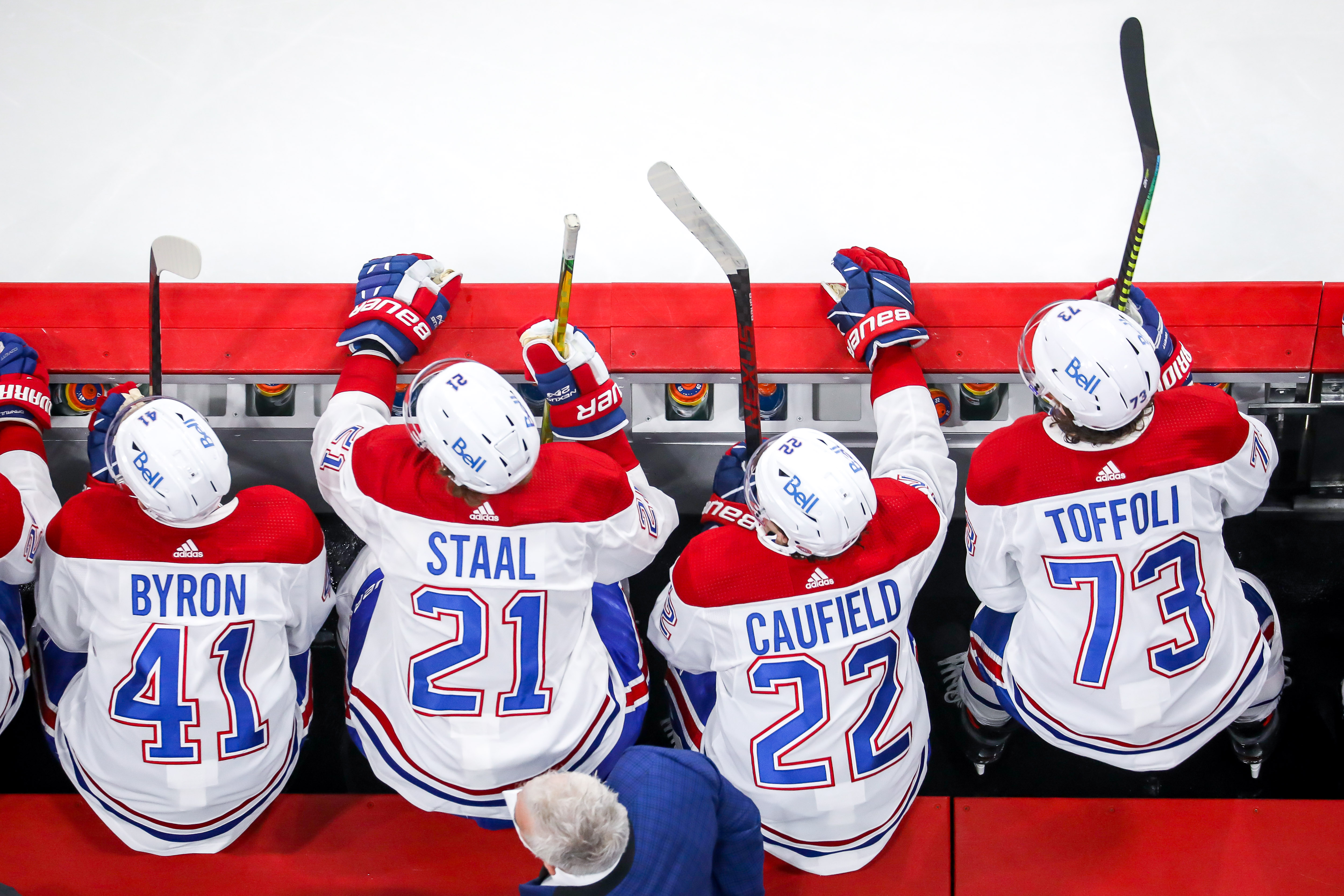 Paul Byron #41, Eric Staal #21, Cole Caufield #22 and Tyler Toffoli #73 of the Montreal Canadiens look on from the bench during third period action against the Winnipeg Jets in Game Two of the Second Round of the 2021 Stanley Cup Playoffs at the Bell MTS Place on June 4, 2021 in Winnipeg, Manitoba, Canada.