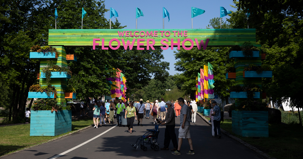 The opening to the PHS Flower Show, held for the first time in history at FDR Park, with a sign that says welcome to the flower show