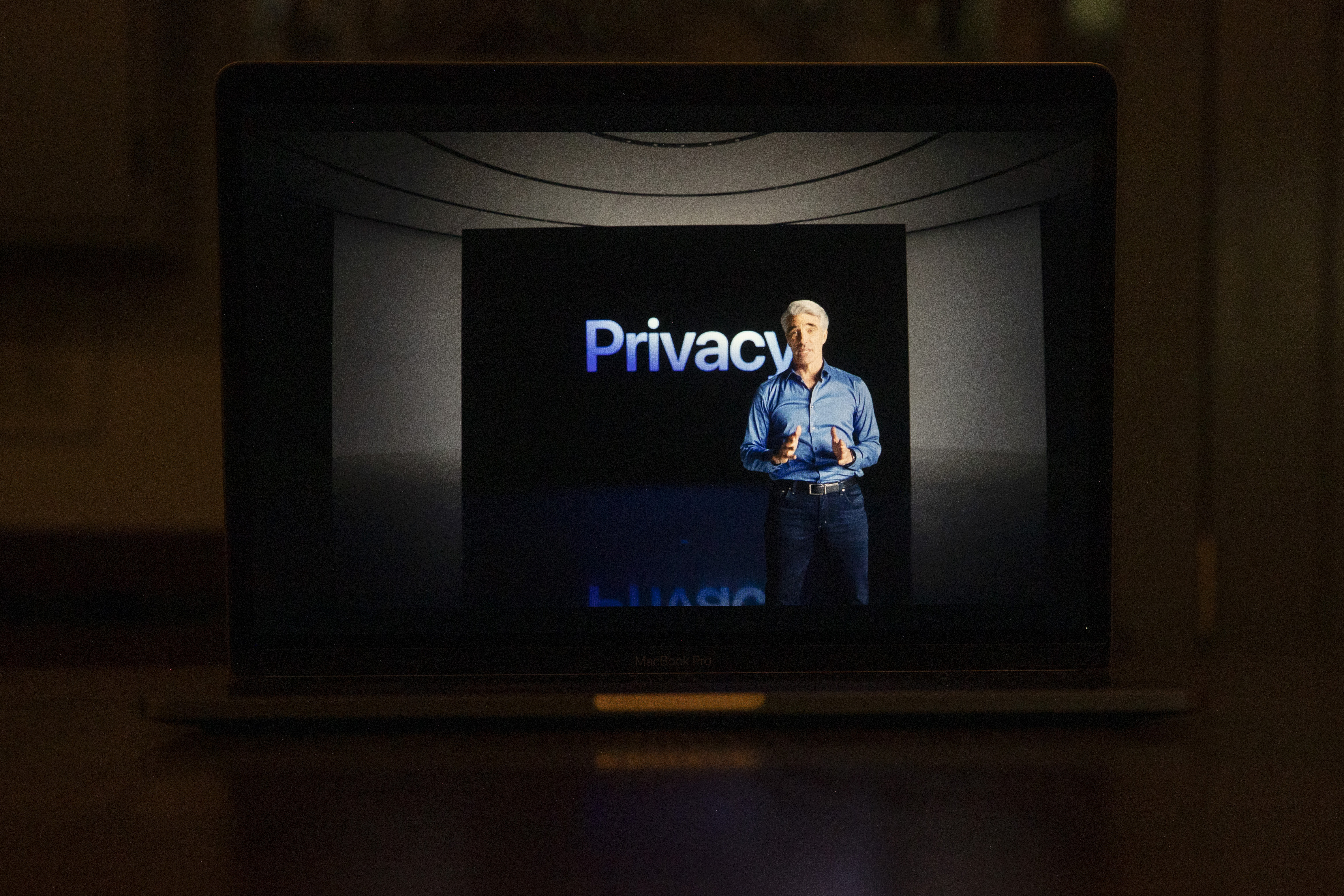 Apple’s senior vice president of software engineering, Craig Federighi, stands in front a screen that reads, “Privacy.”