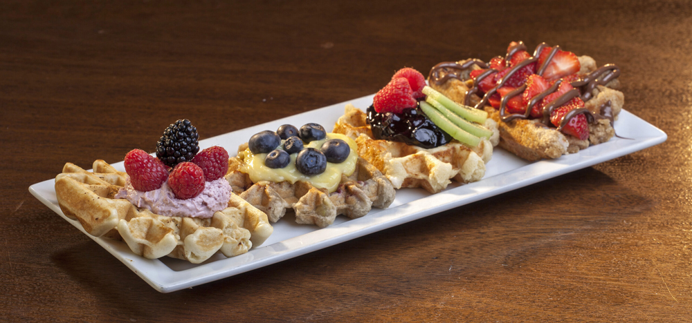 A sampler of four sweet waffle dishes, on the menu at Denver’s Waffle Brothers.