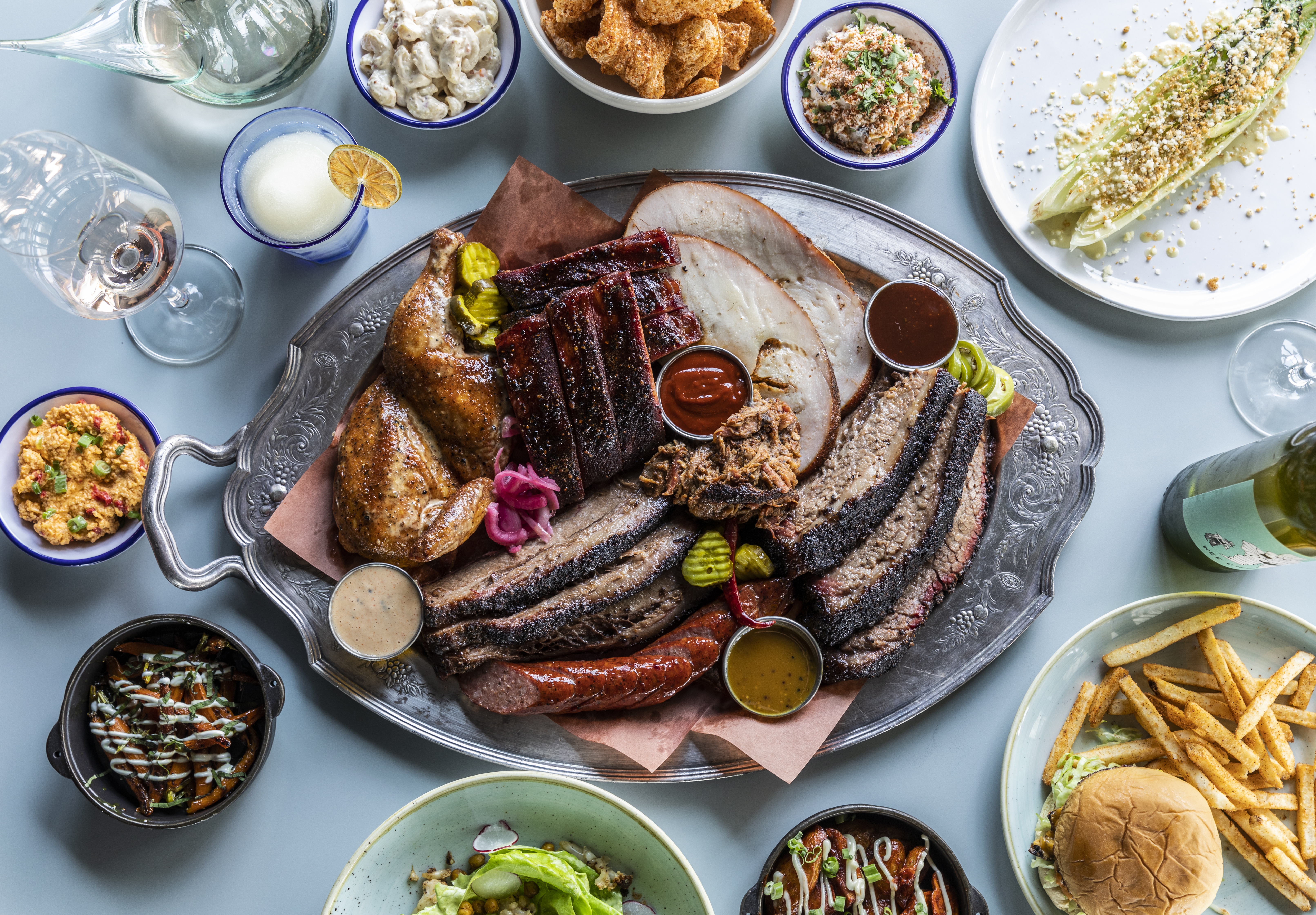 A platter of smoked brisket, turkey, and barbecue sides with all the fixings 