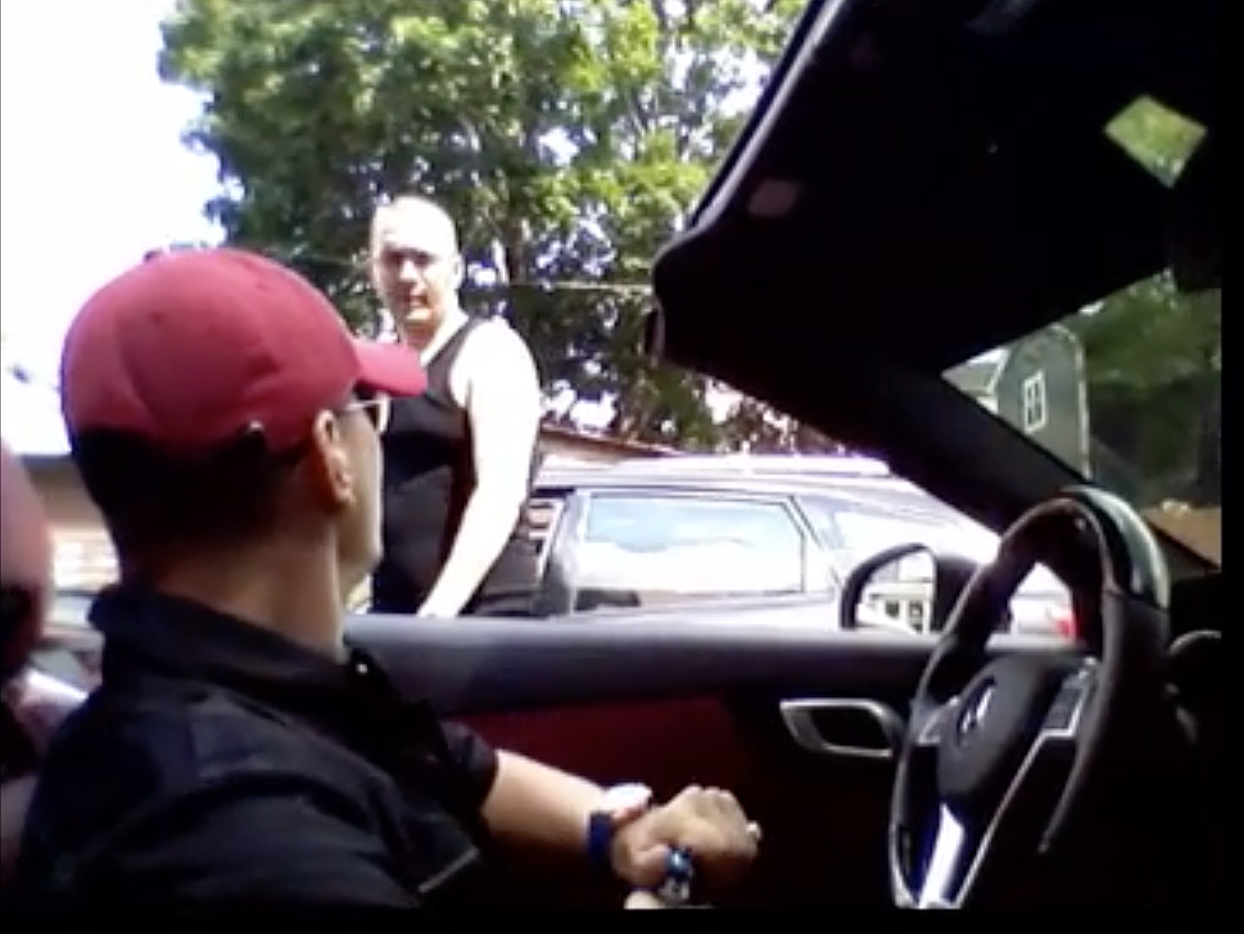 Earl Casteel (standing) was seen in the viral cellphone video from which this image is taken being shot in both legs in 2015 in Irving Park by Thaddeus “T.J.” Jimenez (seated in the car).