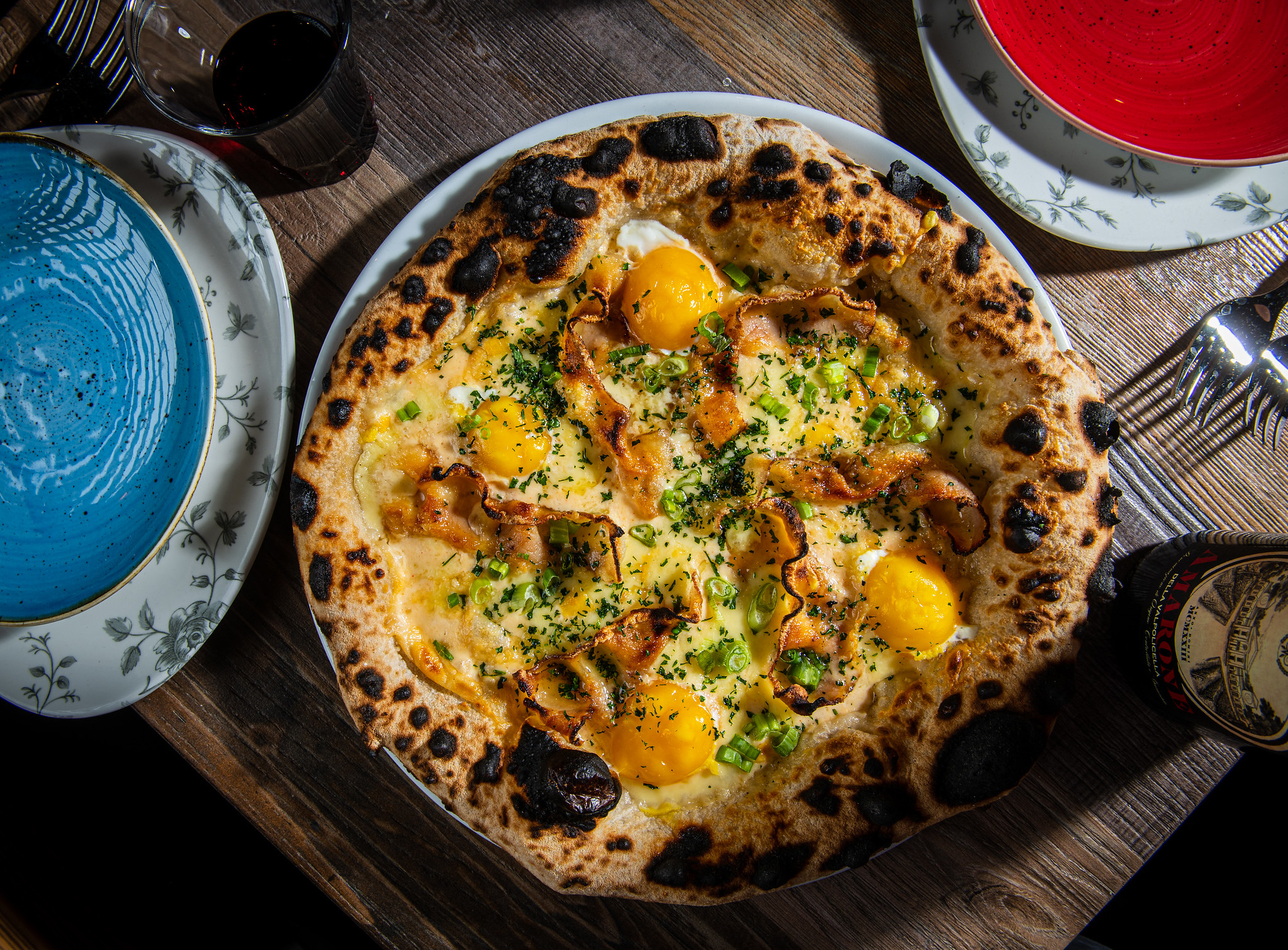 Lupo Pizzeria’s $20 carbonara pizza comes topped with pecorino cream, pork cheek, egg yolk, and a liberal sprinkling of black pepper