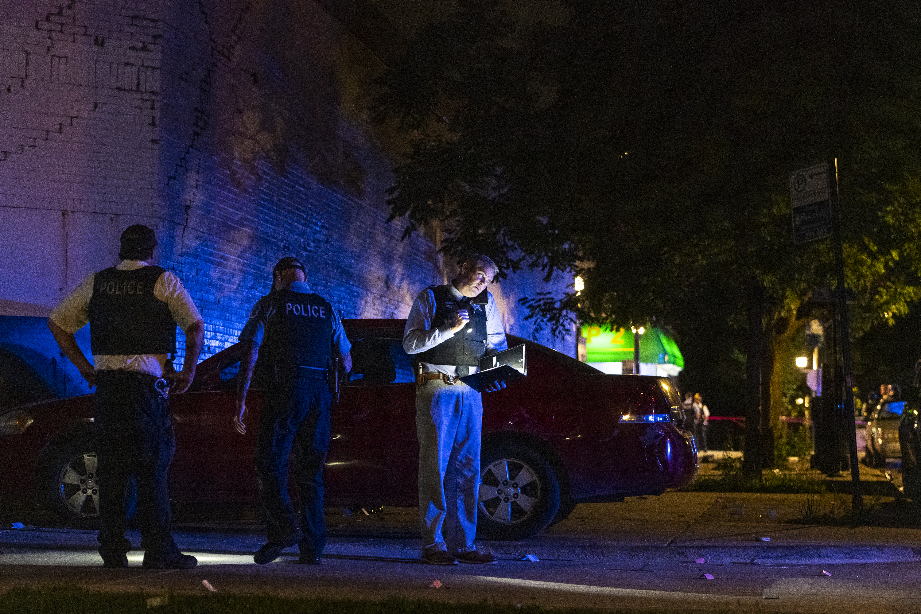Chicago police work the scene where at least eight people were shot in the 6300 block of South Artesian Avenue in the Marquette Park neighborhood on Sunday, June 27, 2021.