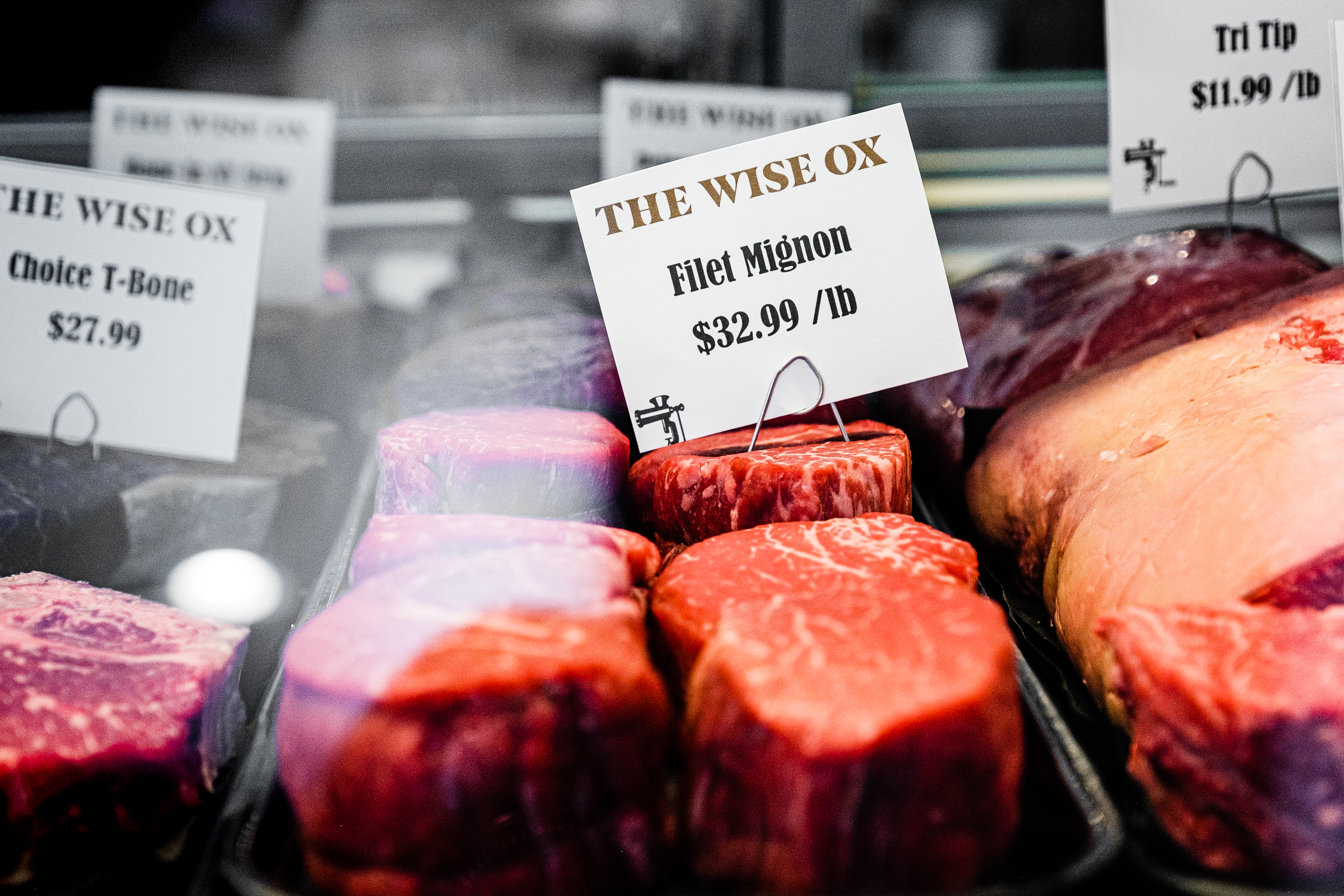 Filet mignon steaks and other cuts inside butcher case at The Wise Ox