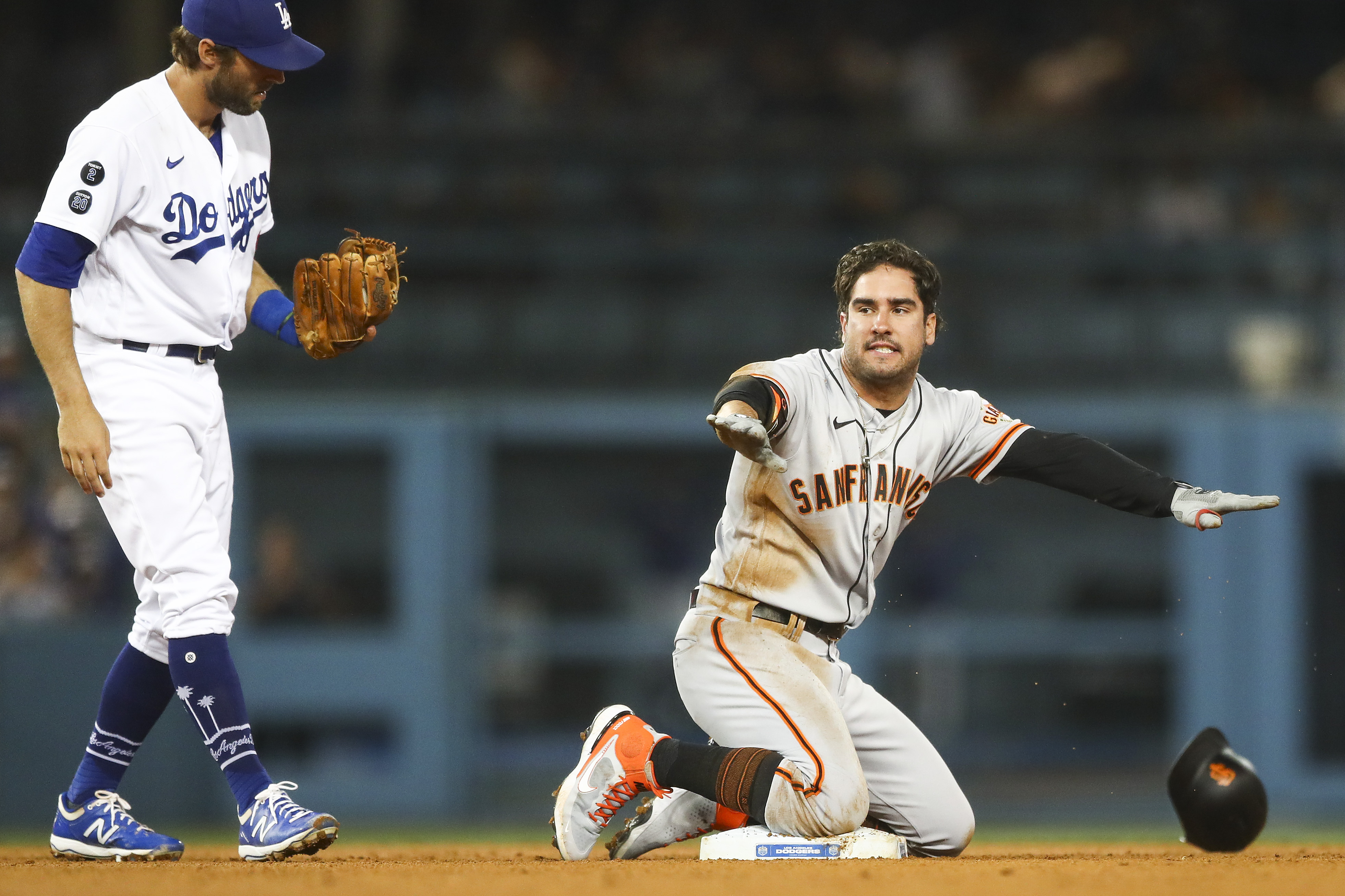 Mike Tauchman of the San Francisco Giants argues the call against him as he is tagged out by Chris Taylor of the Los Angeles Dodgers at second base in the ninth inning at Dodger Stadium on June 28, 2021 in Los Angeles, California.