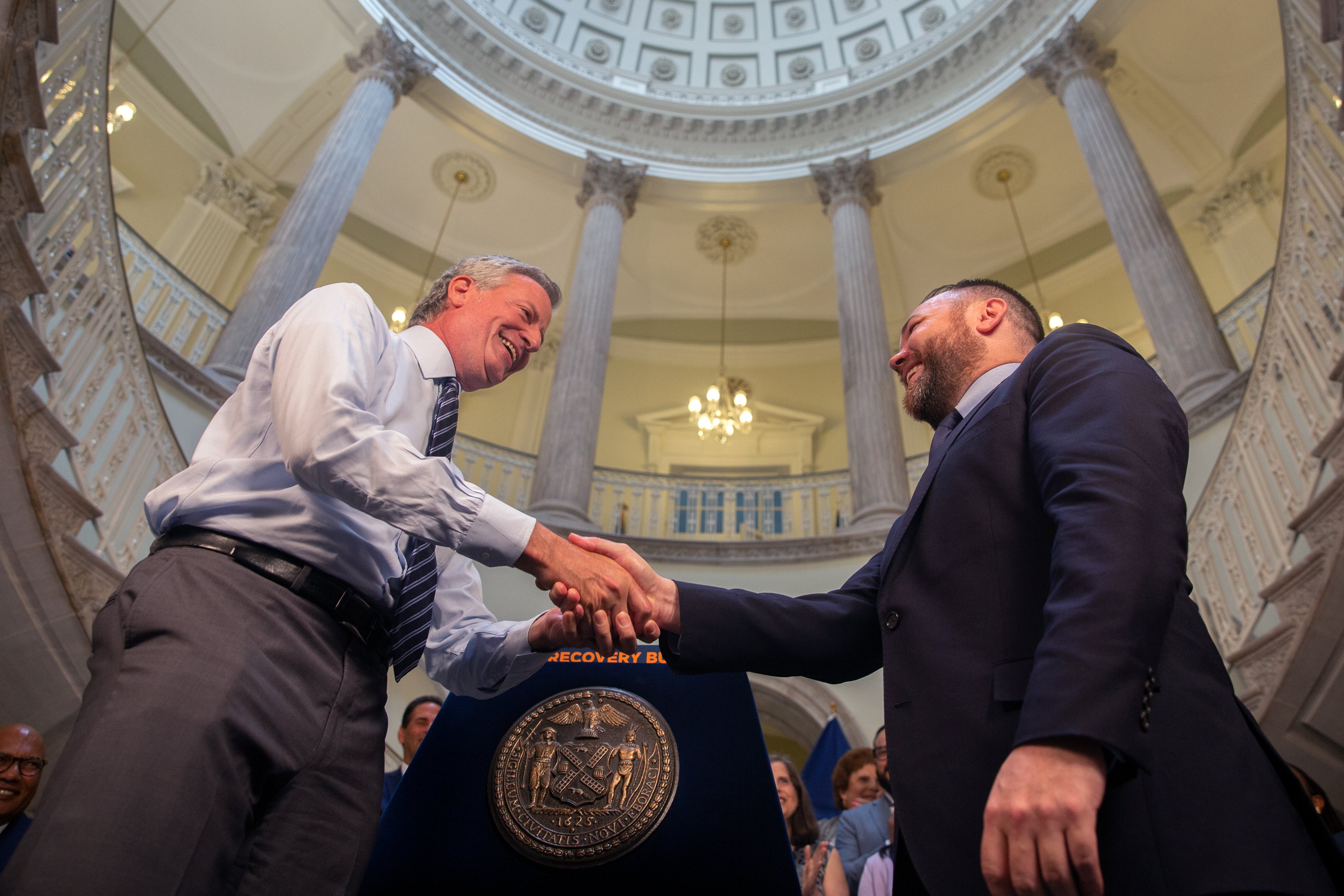 Mayor Bill de Blasio and Council Speaker Corey Johnson shake hands at City Hall on a budget deal, June 30, 2021.